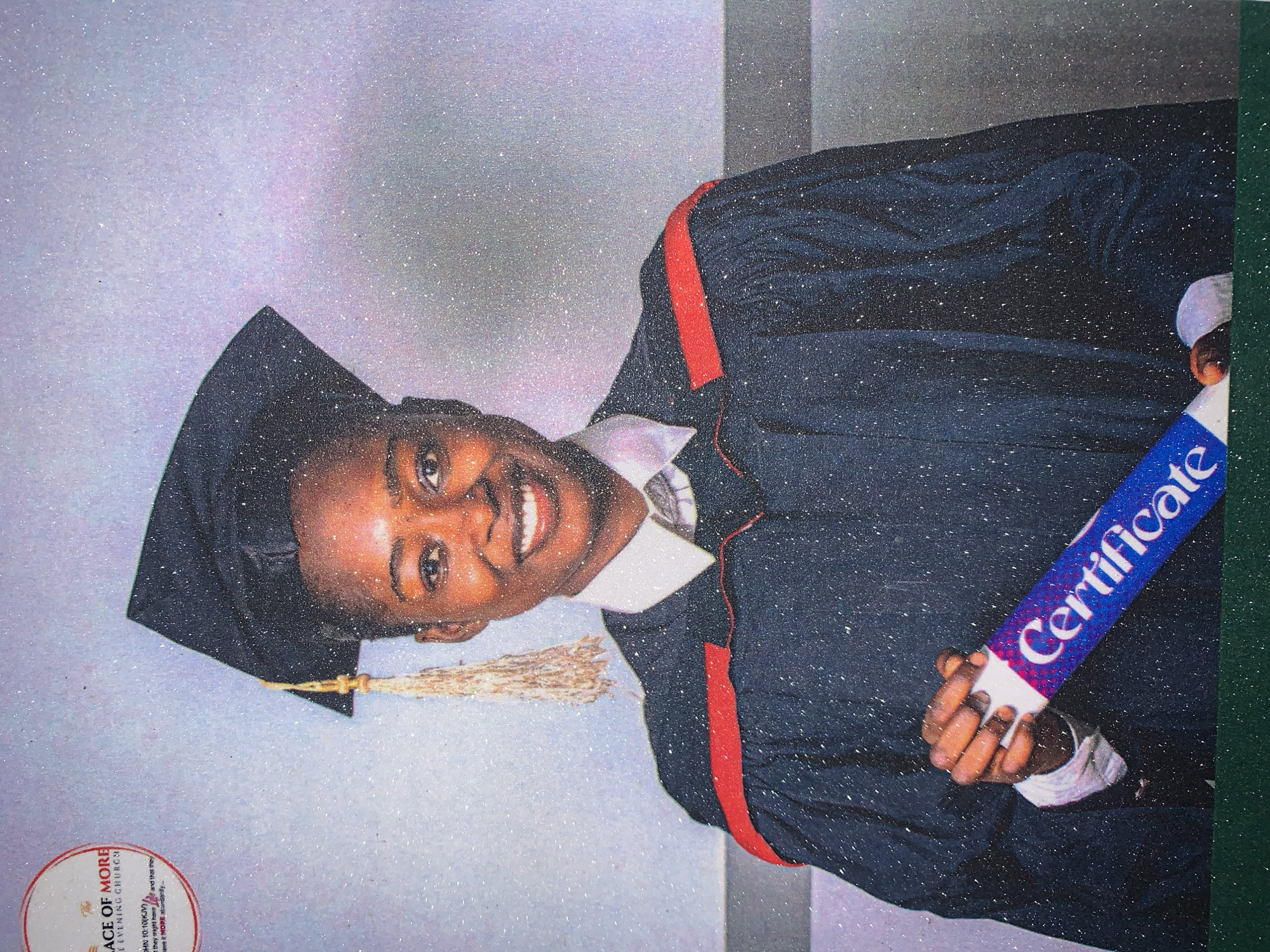A young person is depicted in a graduation photo. They are wearing a graduation cap and gown, holding a rolled-up certificate with the word "Certificate" printed on it. The background is speckled and faded. In the lower left corner, there is a circular logo for "The PLACE OF MORE", including the words "REVENING CHURCH" and a bible verse. The location, city of Rafin Par, Nigeria, is not detectable.
