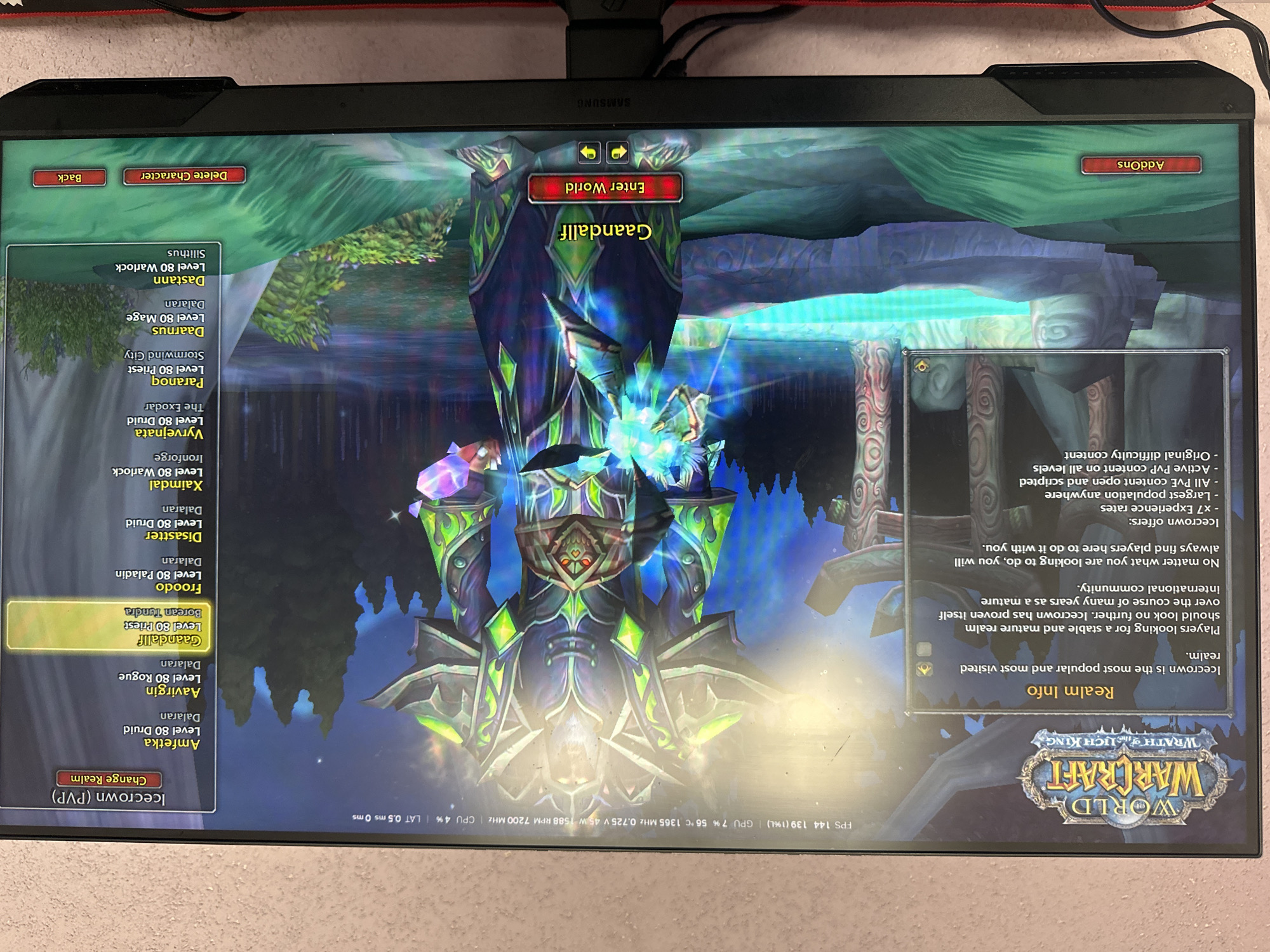 The image shows a screenshot of the character selection screen for the video game World of Warcraft, specifically the Wrath of the Lich King expansion. A large, armored character is displayed in the center of the screen, with character information and realm details visible in panels to the left and right. The "Icecrown (PVP)" realm is highlighted. A character named "Gaandallf," a Level 80 Priest from Borealis Tundra, is selected. Below the character name is an "Enter World" button. The screen is viewed from a slightly elevated, frontal perspective, suggesting it's displayed on a monitor. The background displays a stylized, fantasy landscape. There are no people visible in the scene, and the image itself does not depict or contain any information about the city of Cherven Breg, Bulgaria.