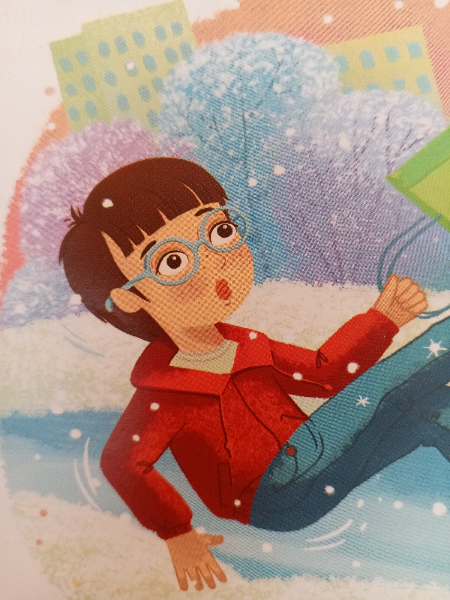 This illustration depicts a young person with brown hair, glasses, and a surprised expression, possibly sliding down a snowy hill. They are wearing a red hooded jacket over a light-colored shirt and dark blue jeans. The background suggests a winter scene with stylized buildings and trees covered in snow. The overall mood is lively and playful, with the falling snow and the subject's dynamic pose conveying a sense of movement and excitement. The lighting suggests it is daytime. The illustration style is cartoonish and colorful, suitable for a children's book or similar publication. There is no visible text.