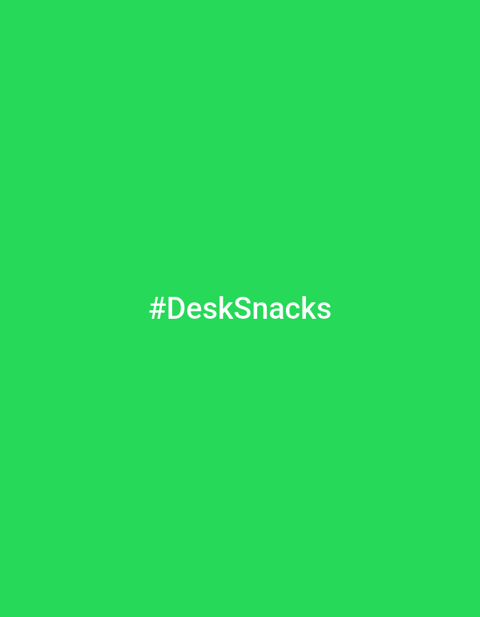 The image shows the hashtag "#DeskSnacks" in white text against a solid green background. There is no evidence to suggest a city, location, or any objects besides the text and background color.