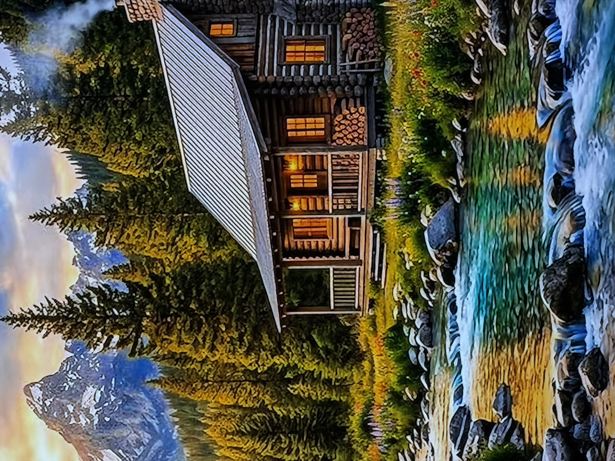 The image, which appears to be rotated 90 degrees counter-clockwise, depicts a serene mountain landscape featuring a rustic log cabin situated beside a flowing river. Dense evergreen forests surround the cabin, and towering, rugged mountains are visible in the background under a soft, diffused sky.
The two-story log cabin, located towards the left side of the scene, is constructed from rough-hewn timber and features a distinctive slanted, corrugated metal roof. Several windows on its facade emit a warm, inviting orange glow, suggesting interior lights are on. Stacks of firewood are neatly piled against the cabin walls. A chimney on the far left side of the roof emits a plume of smoke, indicating a fire is burning inside. A porch or balcony area is also visible on the cabin's front.
To the right of the cabin, a vibrant river or stream flows over rocks and small cascades. The water is clear, displaying varied shades of blue, green, and golden yellow, reflecting the sky and surroundings. The riverbanks are dotted with lush greenery and stones.
In the mid-ground and background, majestic mountains with snowy or rocky peaks rise against a sky painted with soft hues of blue, orange, and yellow, characteristic of either sunrise or sunset. The overall scene evokes a sense of tranquility and natural beauty, suggesting a peaceful, remote setting. No people are visible, but the illuminated cabin and smoke imply human presence. There is no visible text in the image.