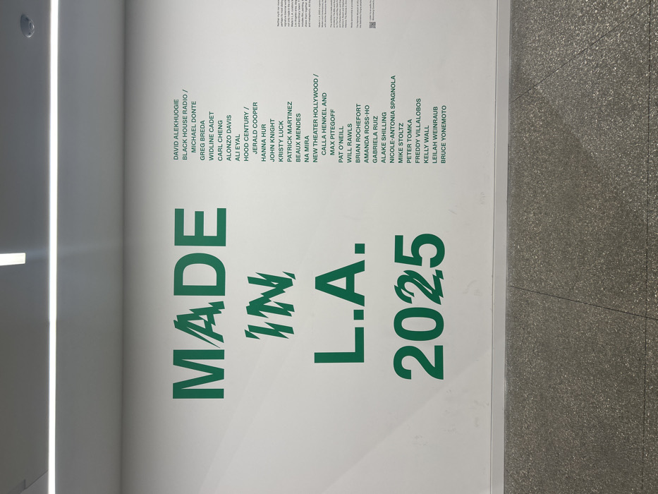 The image displays a poster promoting "MADE IN L.A. 2025," with the text presented in green on a white background. Adjacent to the title are lists of names including David Alekhuogie, Black House Radio, Michael Donte, Greg Breda, Widline Cadet, Carl Cheng, Alonzo Davis, Ali Eyal, Hood Century, Jerald Cooper, Hanna Hur, John Knight, Kristy Luck, Patrick Martinez, Beaux Mendes, Na Mira, New Theater Hollywood, Calla Henkel, Max Pitegoff, Pat O'Neill, Will Rawls, Brian Rochefort, Amanda Ross-Ho, Gabriela Ruiz, Alake Shilling, Nicole-Antonia Spagnola, Mike Stoltz, Peter Tomka, Freddy Villalobos, Kelly Wall, Leilah Weinraub, and Bruce Yonemoto.