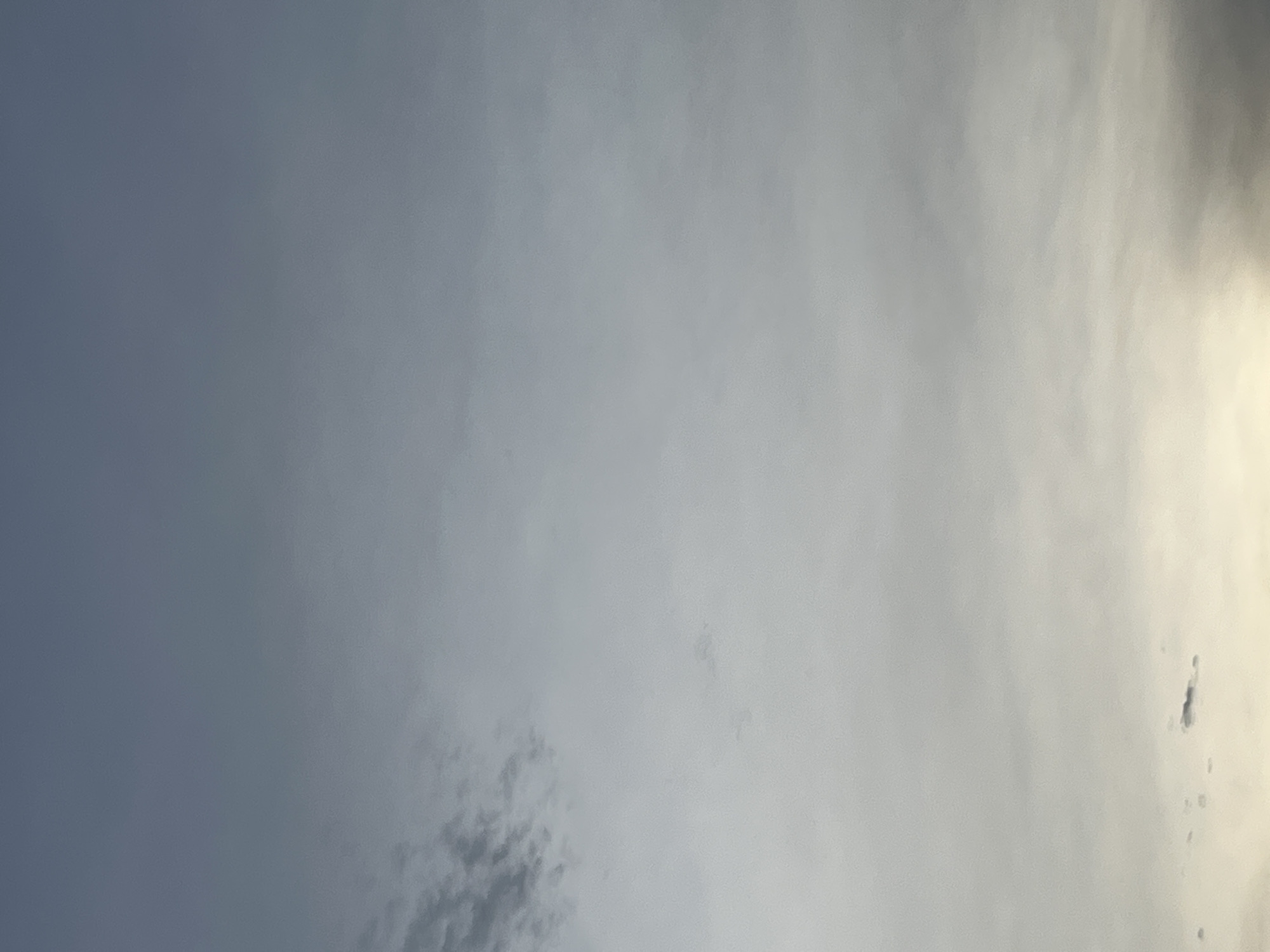 The image shows a sky with clouds, primarily in shades of grey and a hint of yellow at the bottom. The sky appears to be overcast or perhaps it's during dawn or dusk. There are no discernible landmarks or objects that would allow for specific identification of a location within Lhokseumawe, Indonesia. The scene is entirely focused on the atmospheric conditions.