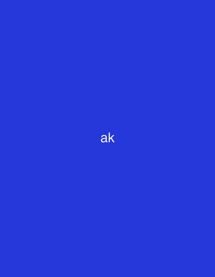 This abstract digital image, situated in Casablanca, Morocco, displays a solid, uniform royal blue background. Centered prominently in the frame are the white lowercase letters "ak", rendered in a sans-serif typeface. A second instance of the same white lowercase "ak" text is positioned in the upper right corner of the frame, also against the blue background. No other subjects, objects, people, actions, or environmental details are visible in the scene.