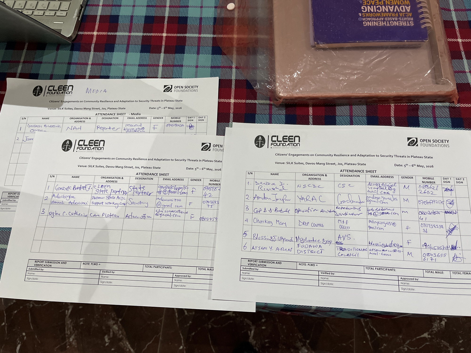 The image shows attendance sheets from CLEEN Foundation events held at SILK Suites, Davou Mang Street, Jos, Plateau State, on May 5-6, 2026. One sheet is labeled "Media" and has one attendee listed: Omegadi Blessing from NAN, a reporter. The other sheets contain lists of attendees from various organizations such as the NSCDC, YARAC, DREP CENTRE, and FUDAWA DISTRICT, with details including names, organization addresses, designations, email addresses, gender, mobile numbers, and signature columns for days 1 and 2. Below the attendance records are sections for report submission and verification, including fields for the names and signatures of those submitting, verifying, and approving the documents. There is also a place for the number of total participants, total males, and total females.