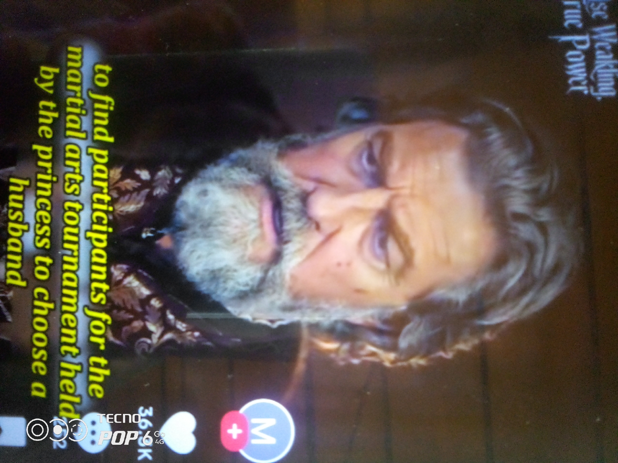 The image shows a man's face with a beard, looking upwards. Text is superimposed on the image, which reads "to find participants for the martial arts tournament held by the princess to choose a husband". Another line of text at the top reads "ise Weaking, True Power". The image also shows icons at the bottom, including "TECNO POP 6" and some social media icons. The overall image is dark and grainy. The location is not discernible from the image.