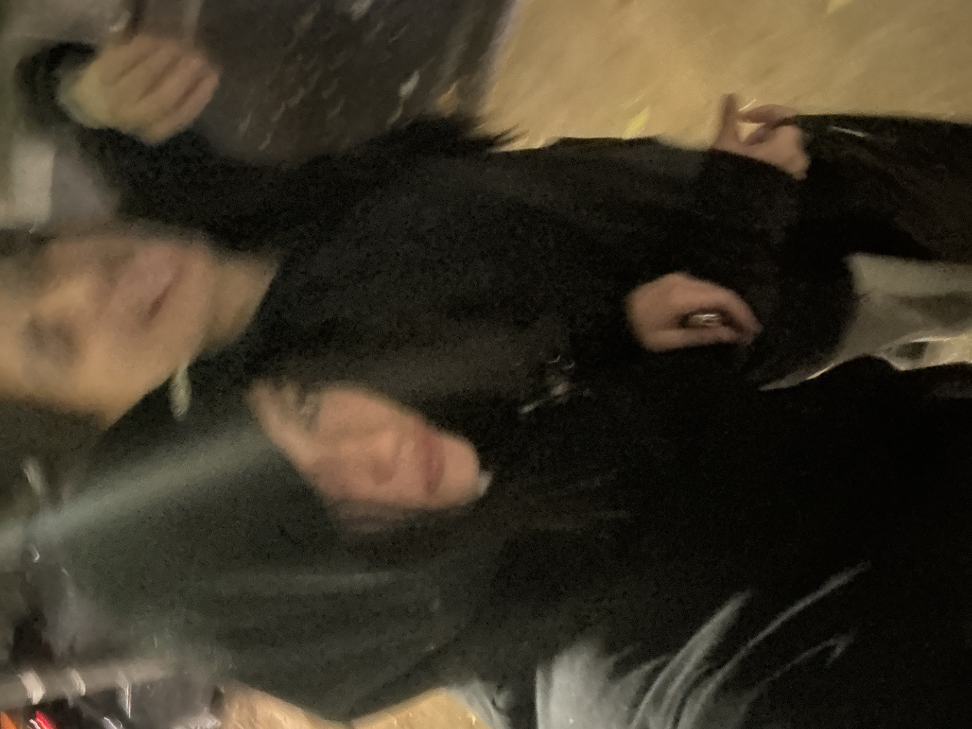 Two individuals wearing dark clothing are present in the image. One individual has short hair. The image appears to be taken at night and may be near street lights. The location is possibly in Buenos Aires, Argentina.