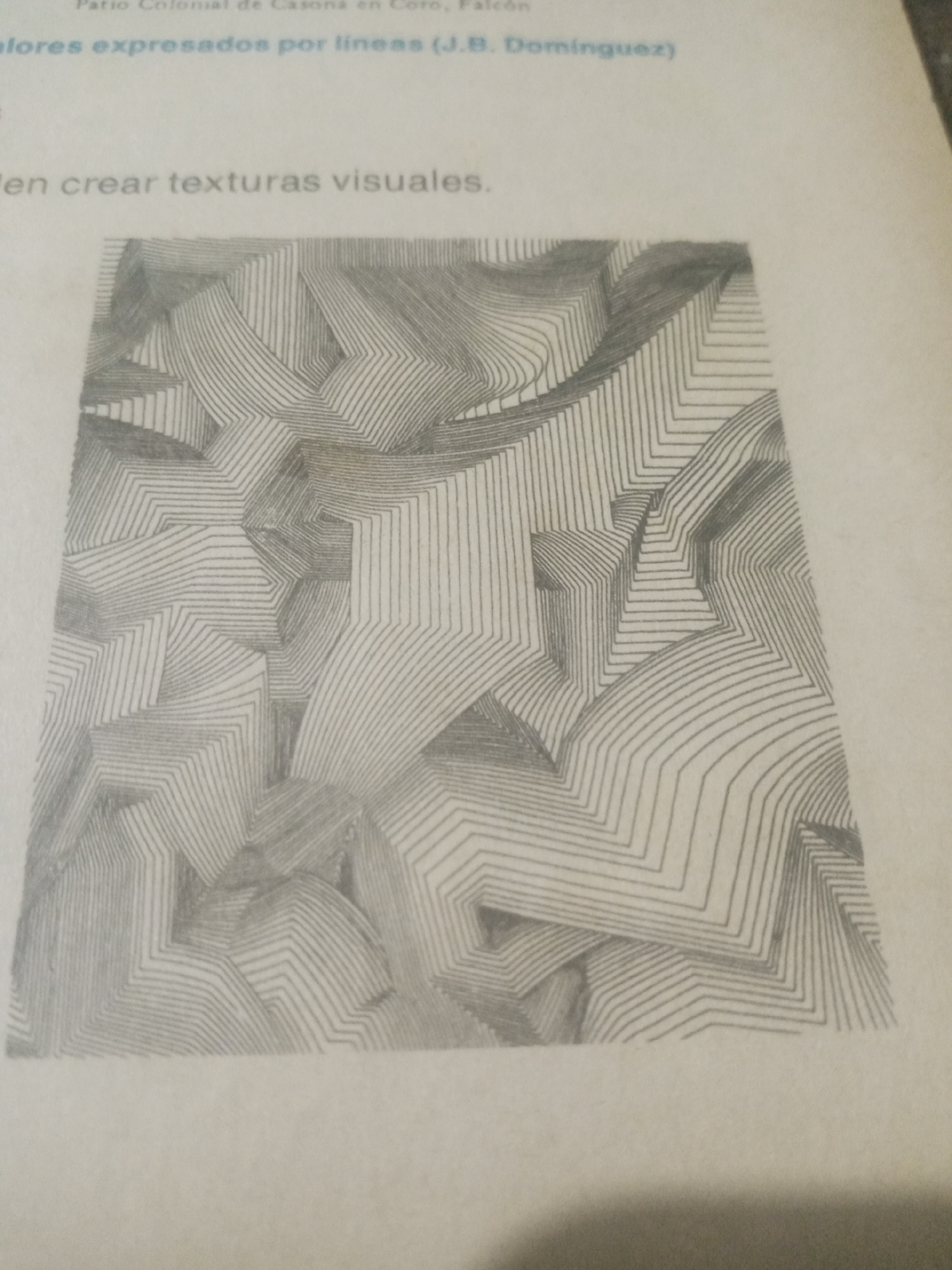 The image displays a pencil drawing with an abstract, geometric pattern of overlapping lines and shapes that create a sense of depth and texture. The lines vary in thickness and density, suggesting shading and form. The drawing appears to be a study in line work and visual texture. The text in the background, partially visible, mentions "valores expresados por lineas (J.B. Dominguez)" and "den crear texturas visuales," indicating that the artwork is related to artistic expression through lines and visual textures, potentially by J.B. Dominguez. The bottom portion of the image is a plain white area. There is no discernible content related to the city of Santa Ana, Venezuela in the image itself.
