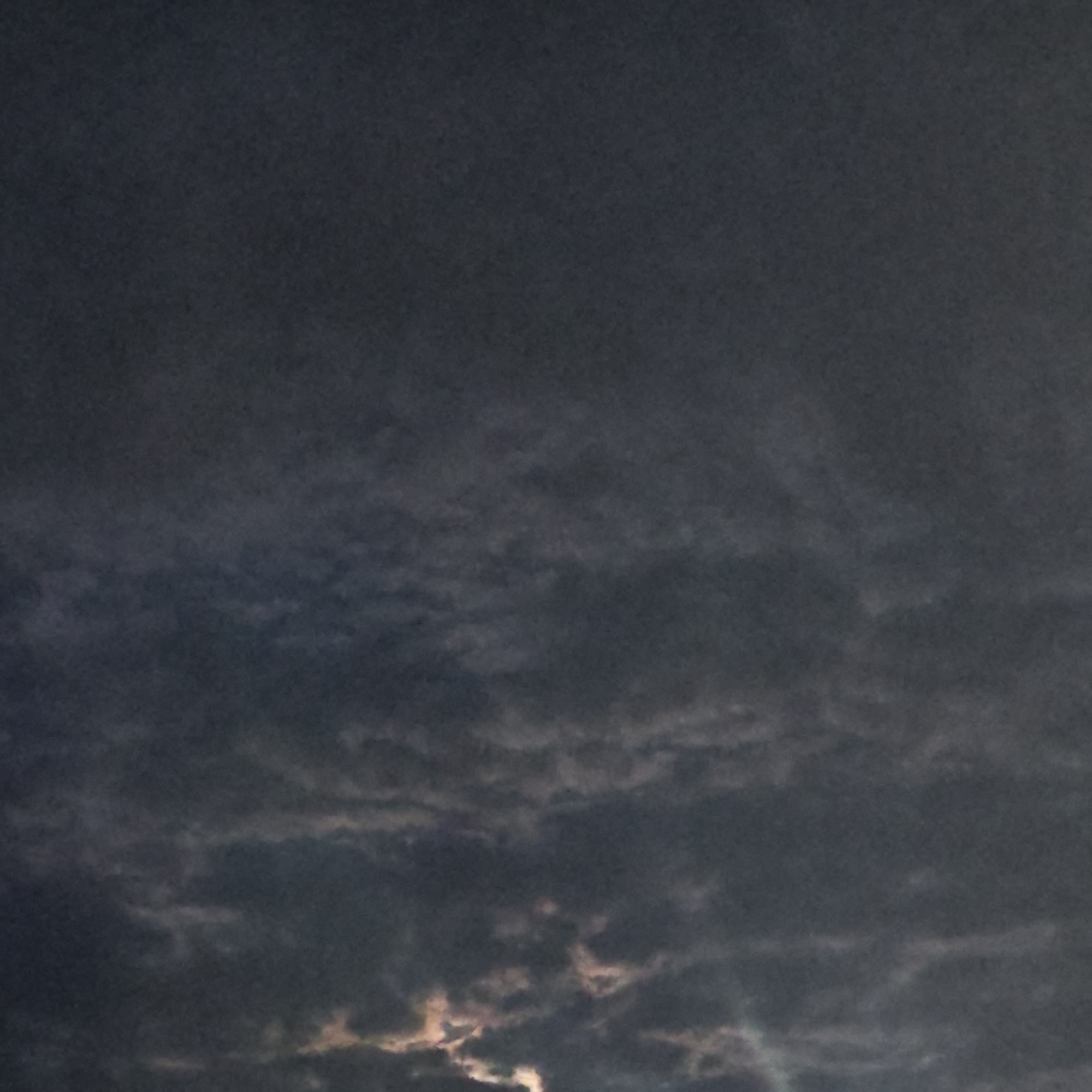 The image shows a dark, cloudy sky. Some light is visible through the clouds near the bottom of the frame. The location is purportedly in the city of Rostov, Russia, although there is no evidence in the image to confirm that.