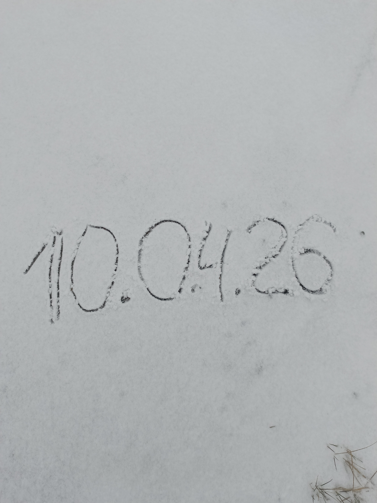 A date "10.04.26" is written in snow. The location is unknown.