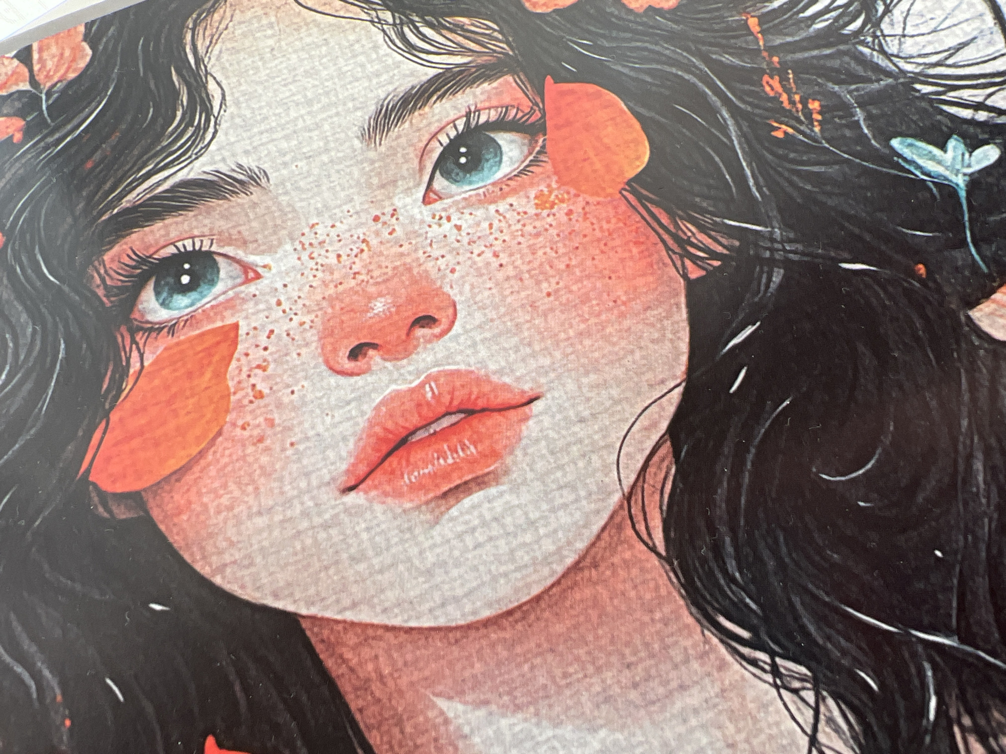 The image is a close-up illustration of a young woman's face, rendered in a watercolor style. Her head is tilted, and she is looking upwards. She has long, dark hair with some wisps falling across her face. Her eyes are a striking blue with prominent eyelashes. Her nose is small, and her lips are full and painted red. Her skin has a rosy hue and is dotted with freckles. There are also what appear to be orange flower petals scattered across her face and hair. The background is a textured, light gray surface, possibly representing paper. The overall impression is one of delicate beauty and a touch of etherealness.
The provided image does not contain any information or visual cues that would allow for the identification of its location in Minsk, Belarus, or any other specific city.