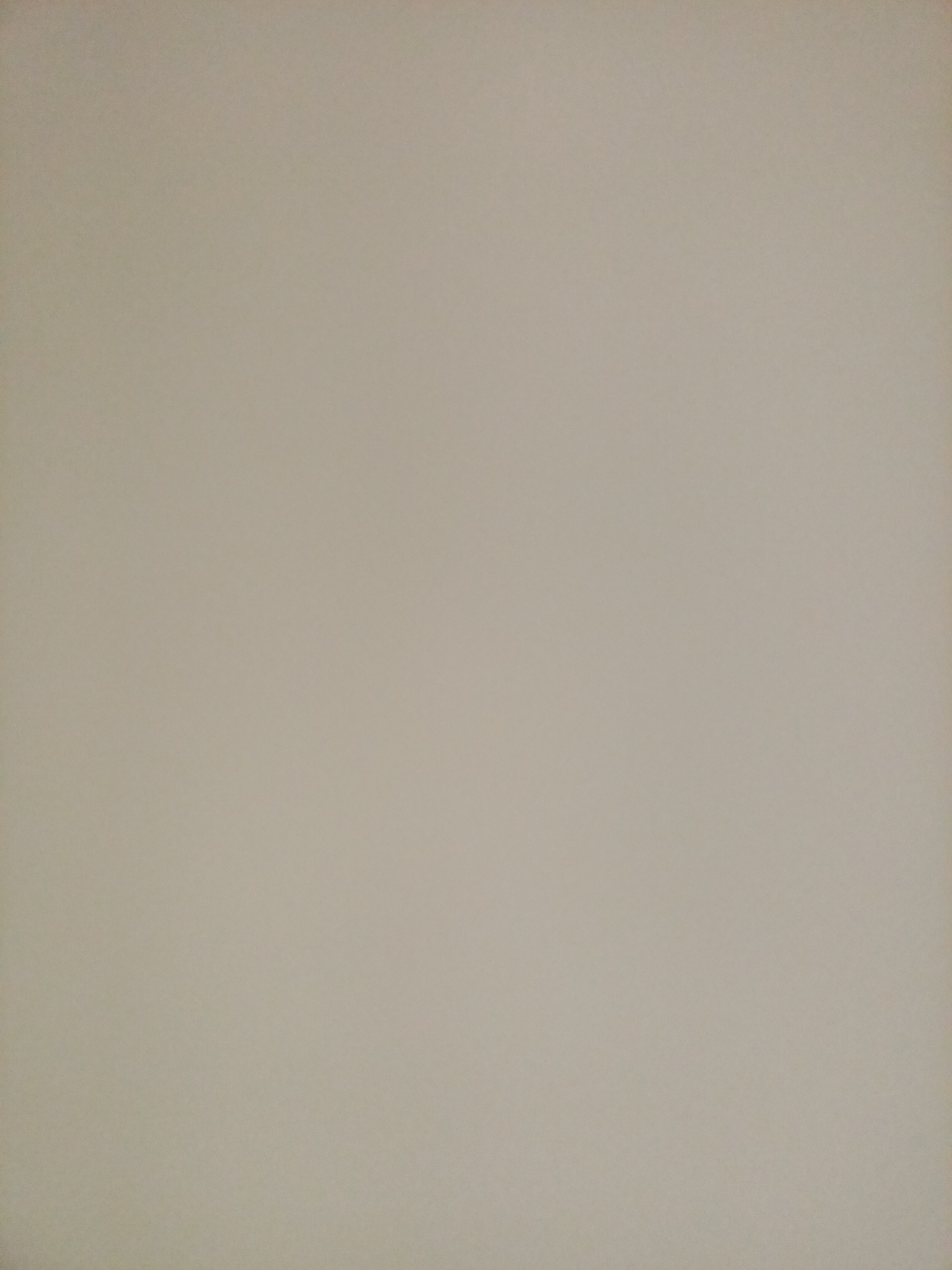 The image shows a plain, light brown textured surface, possibly a wall or a piece of paper. There are no visible objects, people, or any distinguishing features. The lighting appears even, and there are no shadows or highlights to suggest a specific environment. It is not possible to determine the location, even within Rostov-on-Don, Russia, from this image alone.