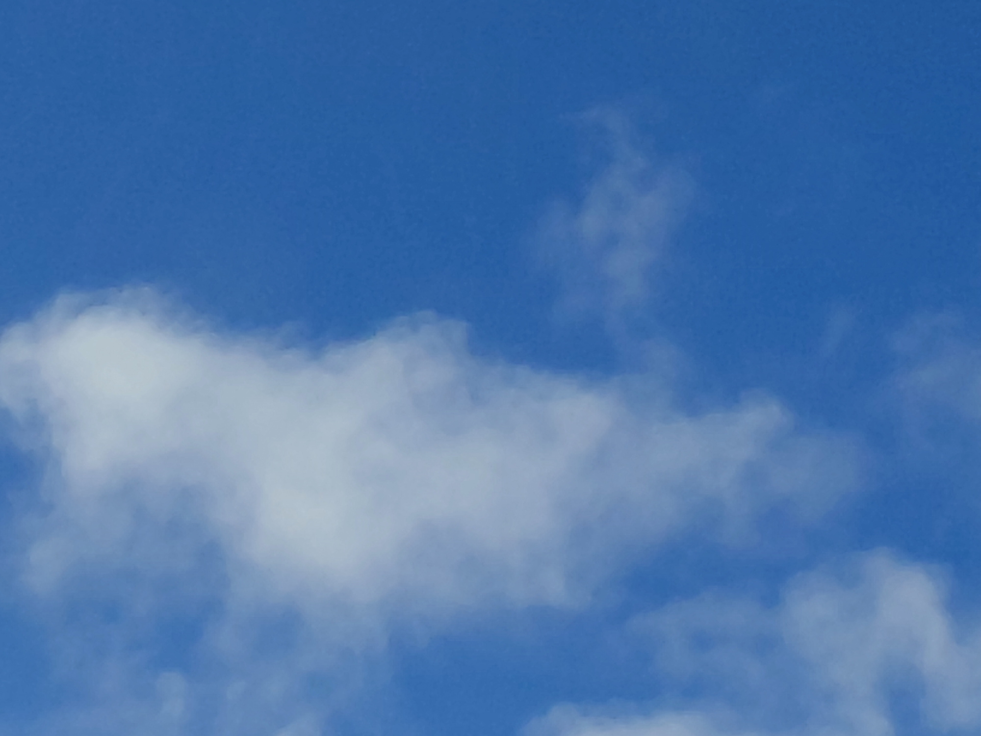 A clear blue sky with scattered white clouds is visible. There are no people, subjects, objects, or actions depicted. The environment is an open sky. The location of Verhnyaya Podstyopnovka, Russia is not discernible from the image.