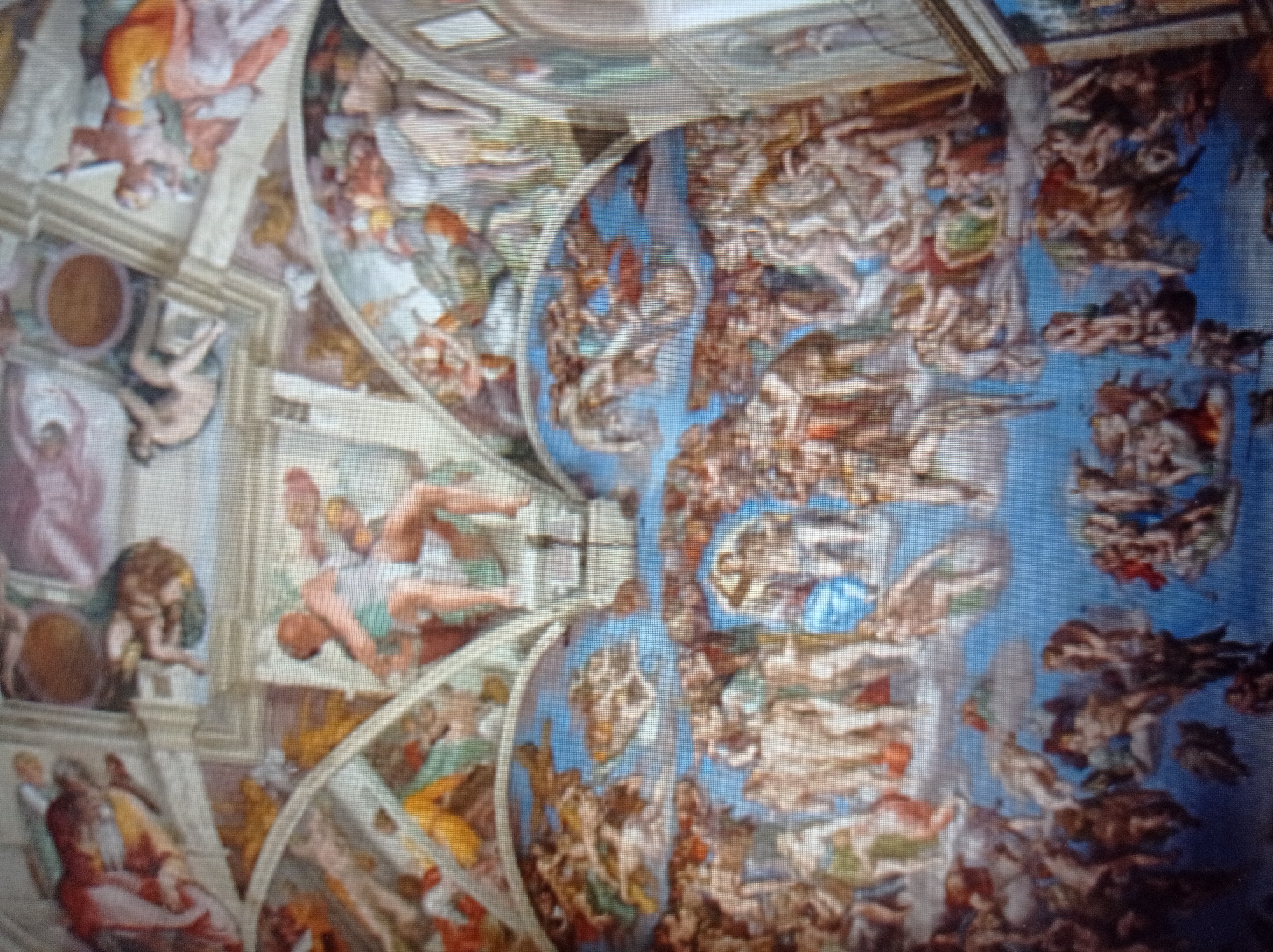 The image shows a fresco depicting a scene with numerous human figures, primarily nude or semi-nude, in various poses and interactions. The painting covers a large, curved surface, suggesting it is a ceiling or vault. The style is classical, with detailed anatomical rendering and dramatic compositions. The figures are arranged in groups, with some appearing to be in motion, flying, or falling. The color palette includes earthy tones, blues, reds, and whites.
This artwork is a detail of the Sistine Chapel ceiling in Vatican City, Rome, Italy, painted by Michelangelo. It is not located in Mukachevo, Ukraine. The specific section depicted is likely from "The Last Judgment" or other scenes from Genesis, characterized by its crowded and dynamic portrayal of human and divine figures.