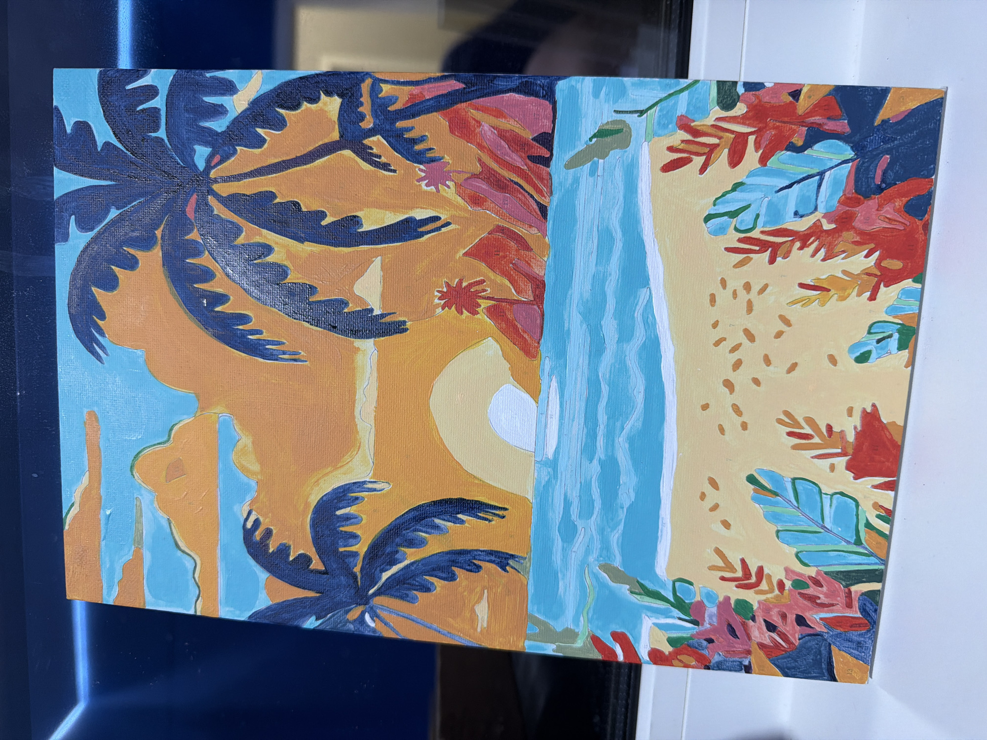 This media file showcases a vibrant, stylized painting on canvas, depicting a tropical landscape. The artwork employs bold, flat colors and distinct, graphic shapes. On the left, large, dark blue palm trees with serrated fronds are prominent, rendered against a background of light blue, suggesting sky or water, and warm orange ground. The fronds feature lighter orange-yellow edges, indicating illumination by a strong light source.
A striking, vertical waterfall, painted in bright light blue with visible brushstrokes, bisects the canvas centrally, flowing downwards into a lighter blue area. To the right of the waterfall, a pale yellow-orange area, reminiscent of sand or earth, is speckled with small, irregular orange marks. This section is adorned with stylized foliage and flowers in a rich palette of reds, oranges, pinks, and touches of light and dark blue, growing from the bottom and top right corners.
In the upper central area, a pale yellow-orange disc, likely representing a sun or moon, is partially visible, enhancing the bright, warm ambiance. Additional abstract shapes in orange and light blue are interspersed on the left side, contributing to the dynamic composition. The painting evokes the feeling of a sunny, exotic paradise. No text is visible within the artwork. The canvas itself is positioned at an angle, possibly leaning against a reflective dark surface.