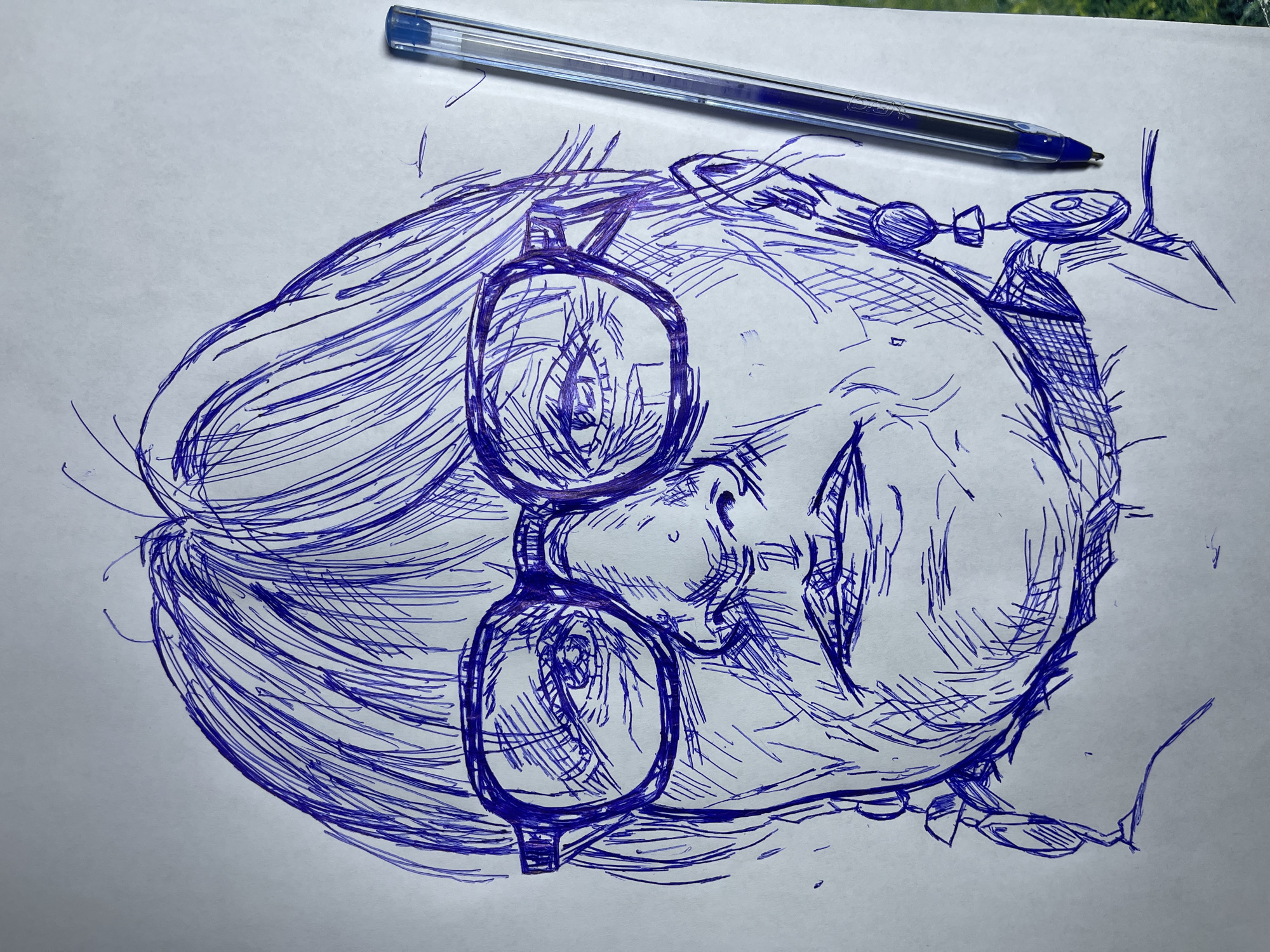 The image is a close-up, low-angle pen and ink sketch of a woman's face. She is wearing large, thick-rimmed glasses and prominent earrings. The sketch is done in blue ink on white paper, with visible hatching and cross-hatching used to create shading and texture. A blue ballpoint pen is lying to the right of the sketch. The background is a plain white surface, with a hint of a green, blurred surface visible at the bottom right, possibly a table or outdoor setting. The style of the sketch is expressive and somewhat abstract, with emphasis on the lines and contours of the face. The sketch does not provide any information about a specific location in Jos, Nigeria.