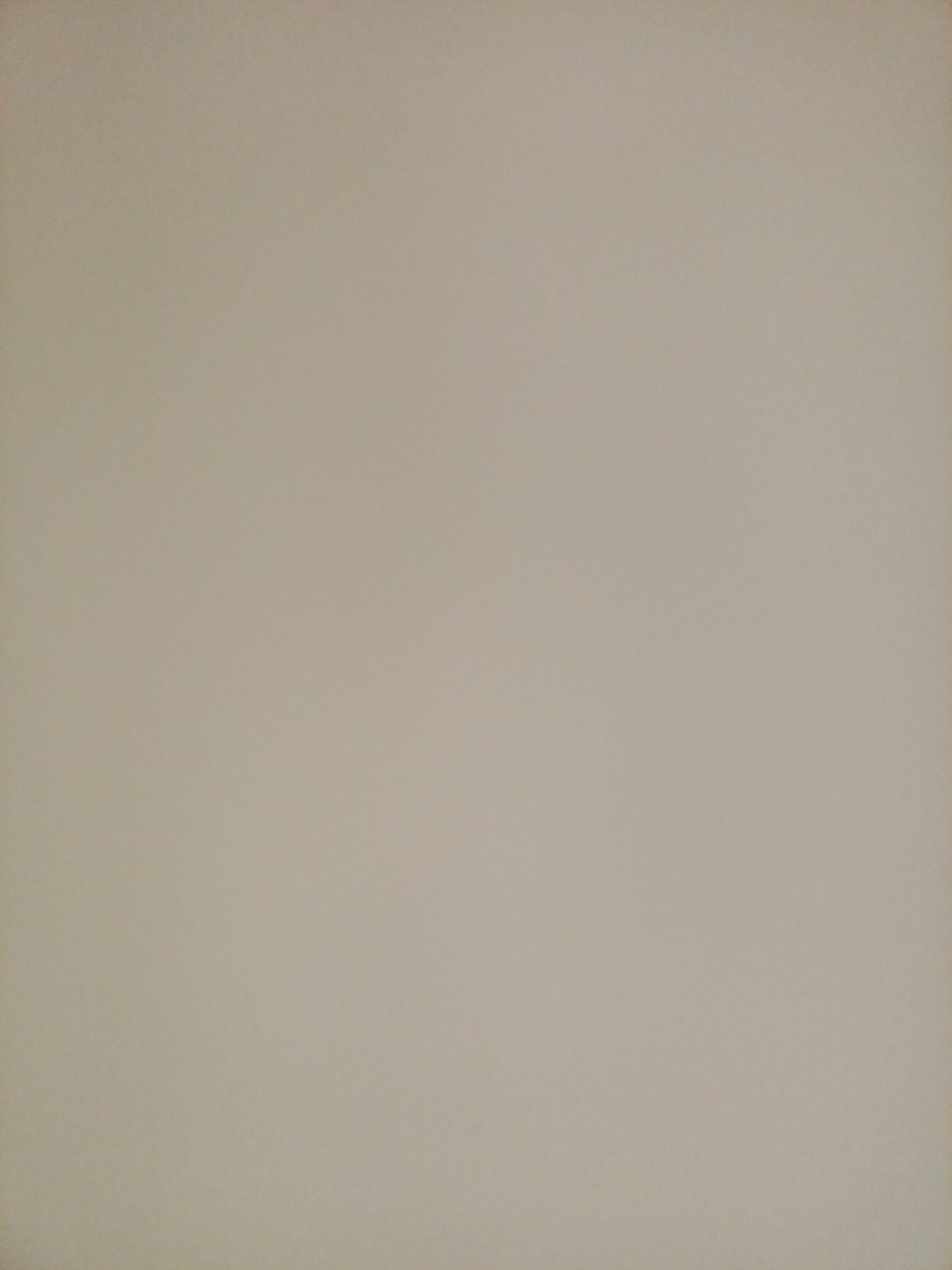 The image depicts a plain, neutral-colored wall, likely made of concrete or plaster, with a slight texture visible. The lighting is even, suggesting an indoor environment or an overcast day. There are no discernible objects, people, or any features that would allow for the identification of a specific location within Rostov-on-Don, Russia, or any other city. The scene is entirely devoid of any visual information that could be used for a forensic or detailed description.