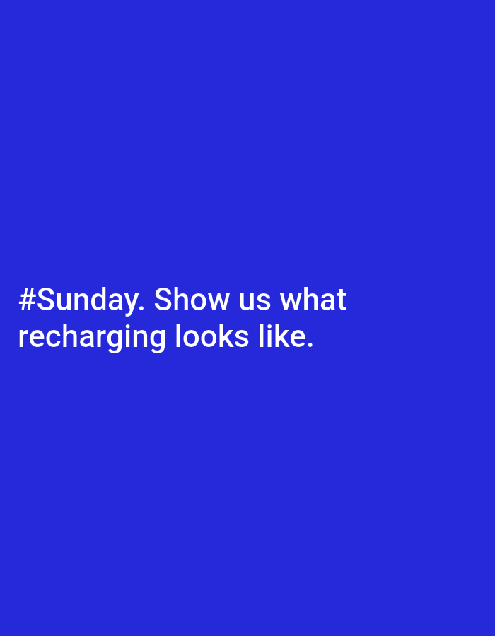 The image is a solid blue background with white text at the bottom left that reads "#Sunday. Show us what recharging looks like." There is no indication of a location in Chaikovsky, Russia or any other city. There are no people, subjects, objects, actions, or interactions present other than the text. The environment consists of the blue background.