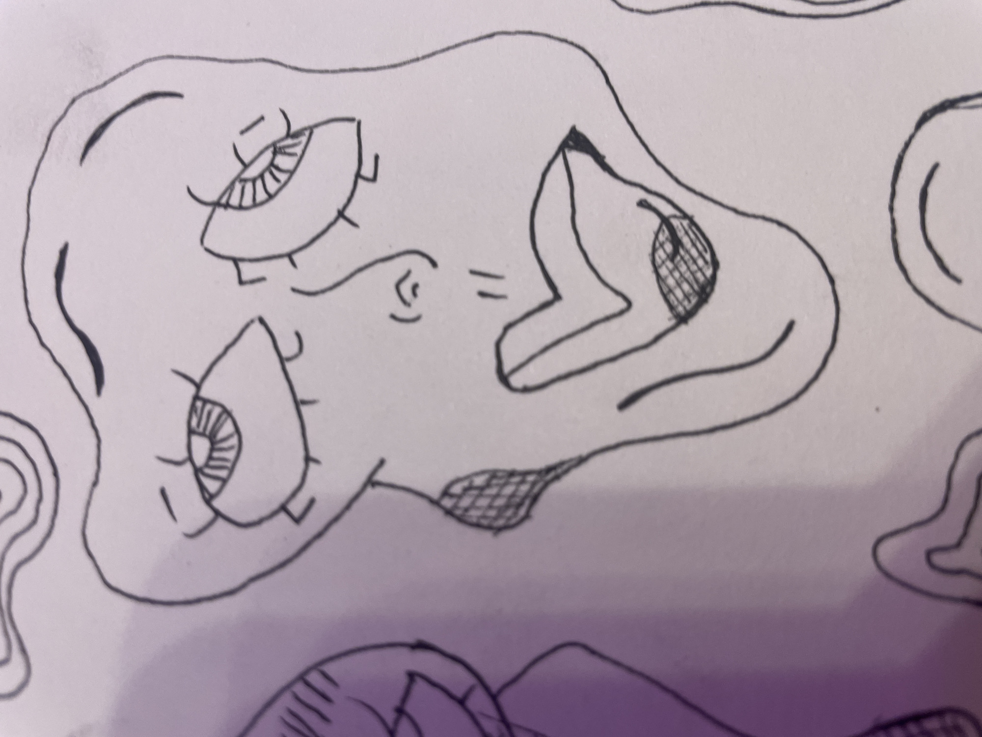 The image is a black and white drawing of a face with abstract, distorted features. The face is outlined with bold, dark lines. The eyes are large and almond-shaped, with detailed irises and lashes. The nose is represented by two short, curved lines. The mouth is wide and expressive, with full lips. There are shaded areas on the cheeks and on the lower lip, creating a textured effect. The drawing is presented on a white background with some areas of light purple shading. The style is surreal and expressive. The image does not depict a specific location in a city.