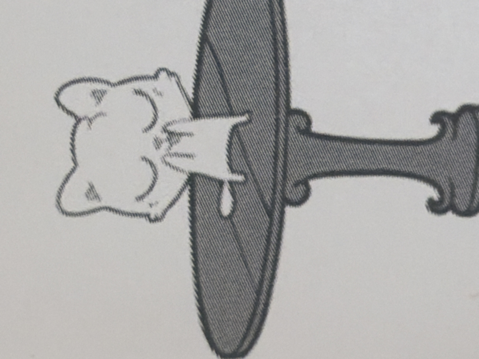 This is a black and white, stylized illustration of a cartoon cat sitting at a round table. The cat has its eyes closed and its paws together in a prayer-like or pleading gesture. The table has a textured surface and a decorative base. The background is plain white. There is no indication or context of this image being located in Arcahueja, Spain.