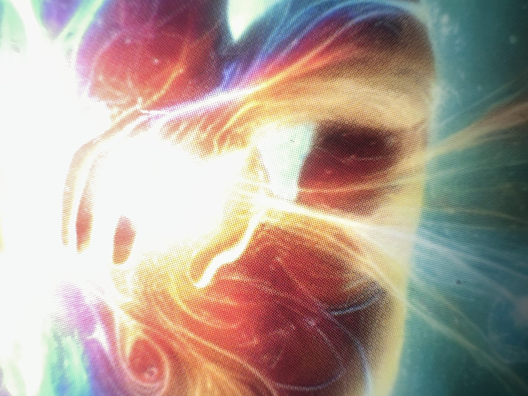 The image is a close-up, abstract depiction of what appears to be a human hand emitting bright, colorful energy. The hand is the central subject, rendered in a way that suggests movement or a powerful force being expelled. Swirling patterns of light, in shades of white, yellow, orange, red, purple, and blue, emanate outwards from the hand, creating a dynamic and energetic visual effect. The overall impression is one of immense power or perhaps a spiritual or supernatural phenomenon.
The texture of the image suggests it might be a photograph of a screen displaying a digital artwork or special effect, as there's a visible grid pattern overlaying the colors. This grid suggests the image is not a raw, unedited photograph of a real-world event.
There is no discernible time of day, weather, specific location cues, or clear indication of emotions, as the focus is on the abstract representation of energy and form. No text is visible in the image. The provided location context of "Letterkenny, Ireland" does not seem to relate to any visually identifiable elements within the image itself.