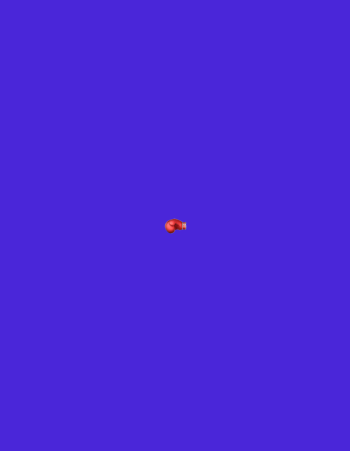 The image is a vertical, medium shot of a single red boxing glove. The glove is positioned centrally in the frame, slightly off-center to the left, and angled so that the thumb is pointing upwards and to the right, and the fingers are pointing downwards and to the left. The background is a solid, vibrant blue. There are no people, environmental features, or any other objects present in the image. The scene is devoid of any context that would suggest a specific location, including Burgas, Bulgaria.