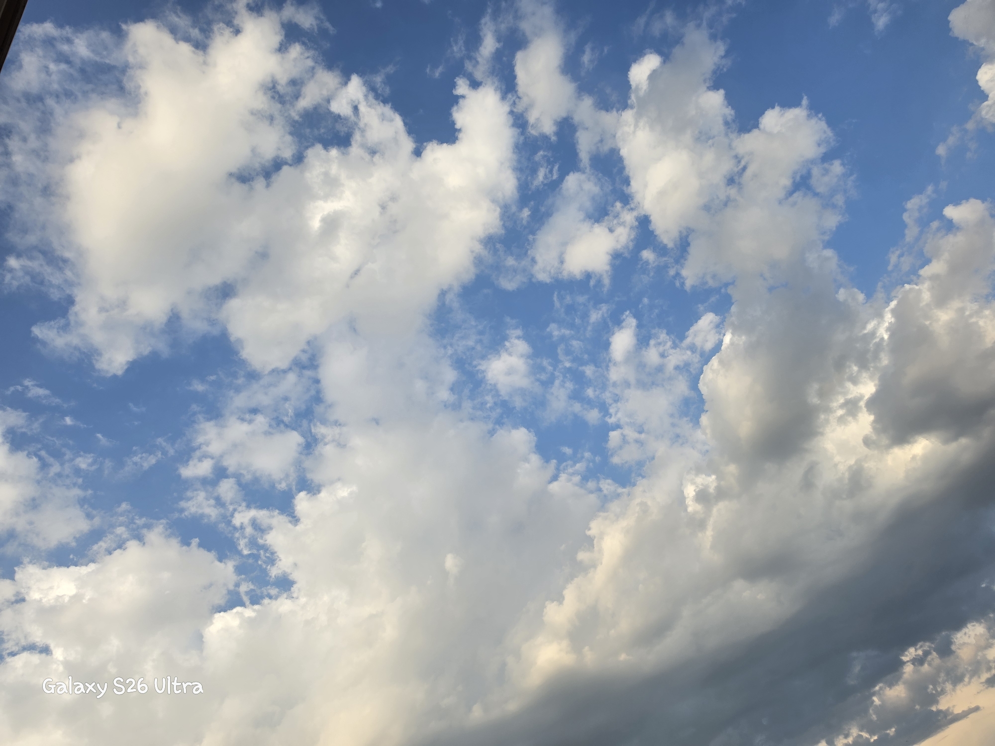 This is a photograph of a sky filled with white and grey clouds against a bright blue background. The image also contains a watermark in the bottom left corner that reads "Galaxy S26 Ultra." No people, subjects, objects, or actions are visible in the scene. There is no information in the image to suggest the location is Plovdiv, Bulgaria.