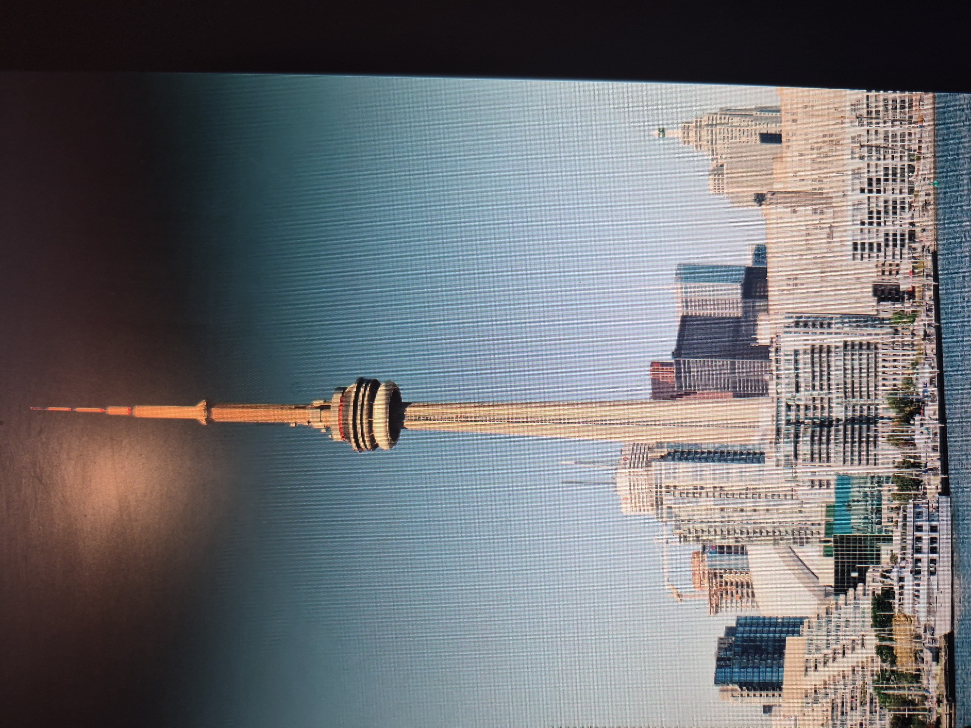 The image shows the Toronto skyline, featuring the CN Tower. There are many buildings to the right of the tower. The image is rotated 90 degrees counter-clockwise. The location is not Yerevan, Armenia.