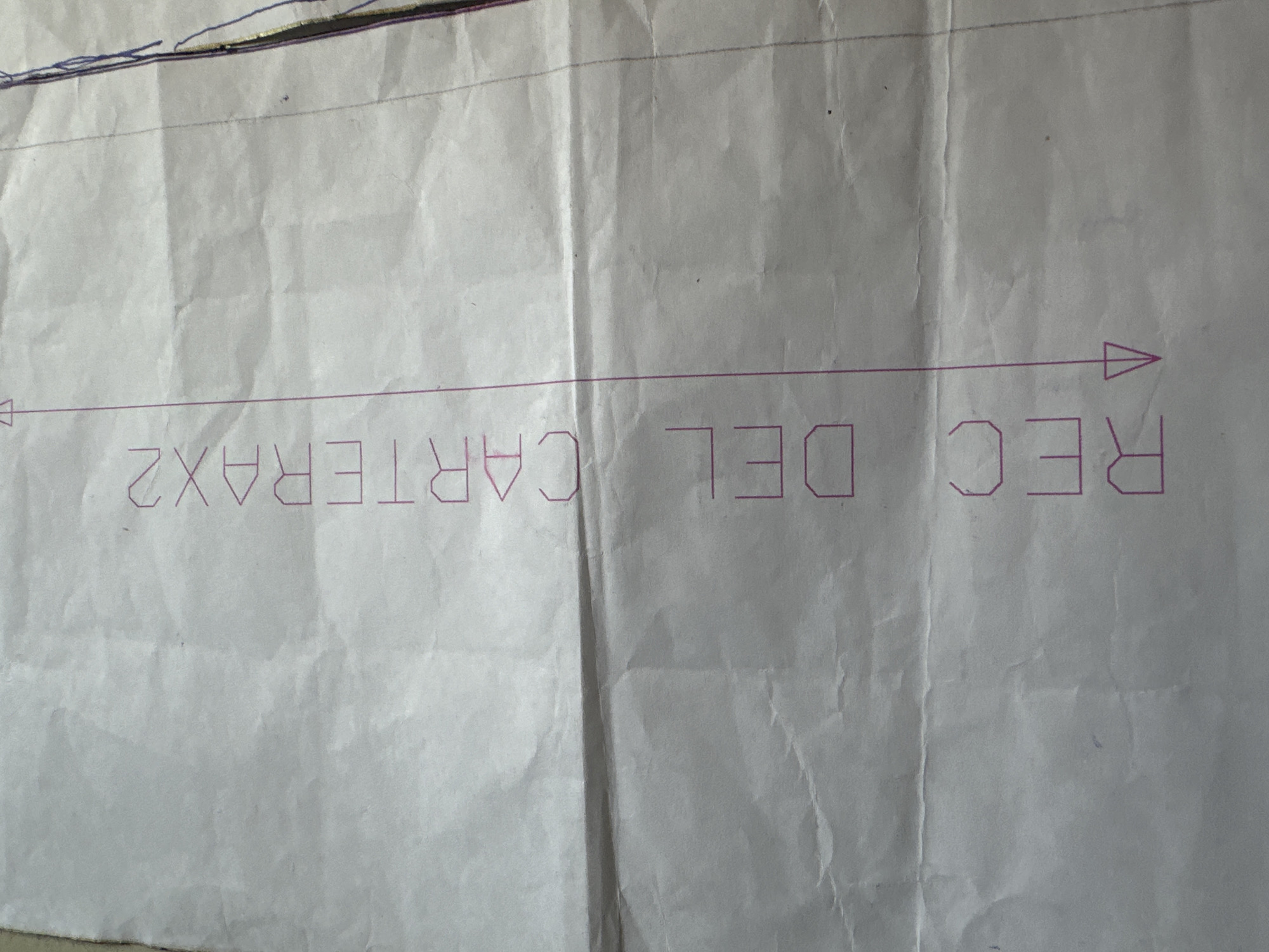 A close-up photograph shows a white sheet of paper with text printed in purple ink. The text reads "REC DEL CARTERAX2" with an arrow pointing to the right. The paper is creased and wrinkled. No people or objects are visible other than the paper. The location, Buenos Aires, Argentina, cannot be determined from the visual information.