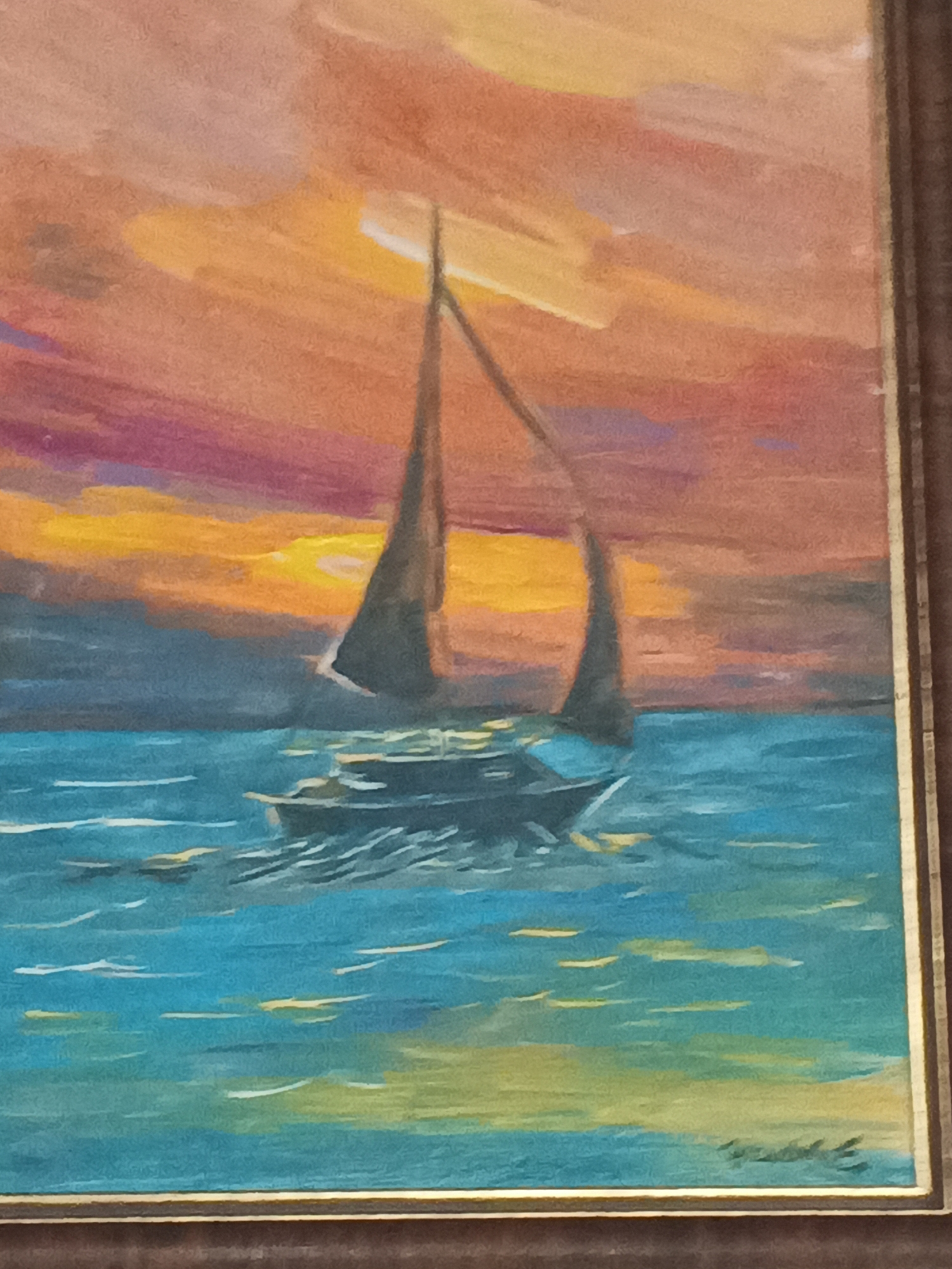 This is a painting of a sailboat on the water during sunset. The sky is a dramatic mix of orange, yellow, and purple, suggesting a vibrant and colorful sunset. The water is a deep blue with streaks of yellow and white, indicating movement and possibly reflections of the sky.
The sailboat is depicted with two sails, one larger than the other, and a hull that appears to be dark. The boat is positioned in the middle ground of the painting, creating a focal point. The overall impression is one of peacefulness and natural beauty, with the setting sun casting a warm glow over the scene. The painting is framed by a dark brown border. The artist's signature is visible in the bottom right corner of the painting.