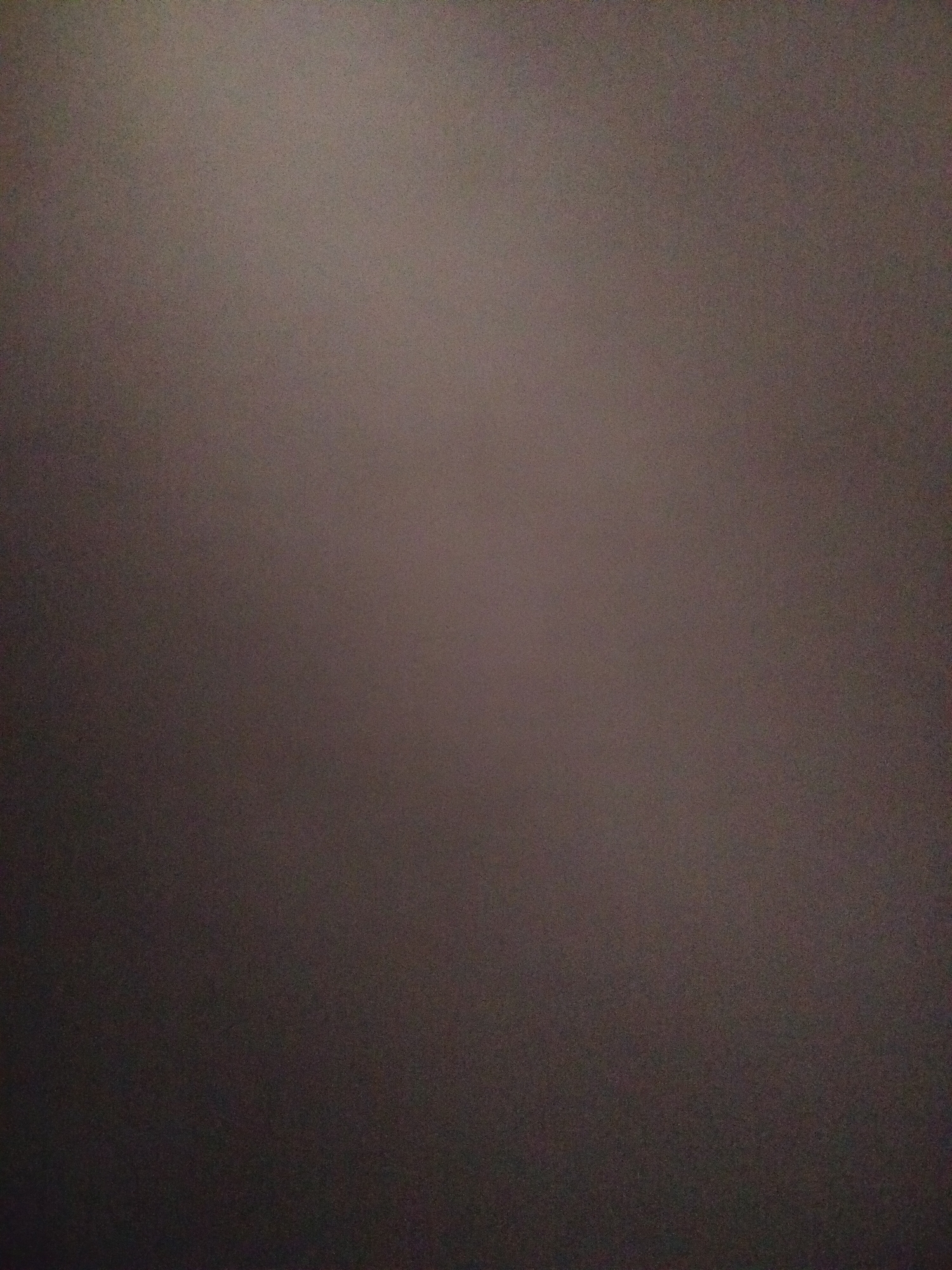 The image is a blurred, slightly grainy photograph with varying shades of dark brown and gray. There are no identifiable subjects or objects. The image provides no clues to the location in Yerevan, Armenia.