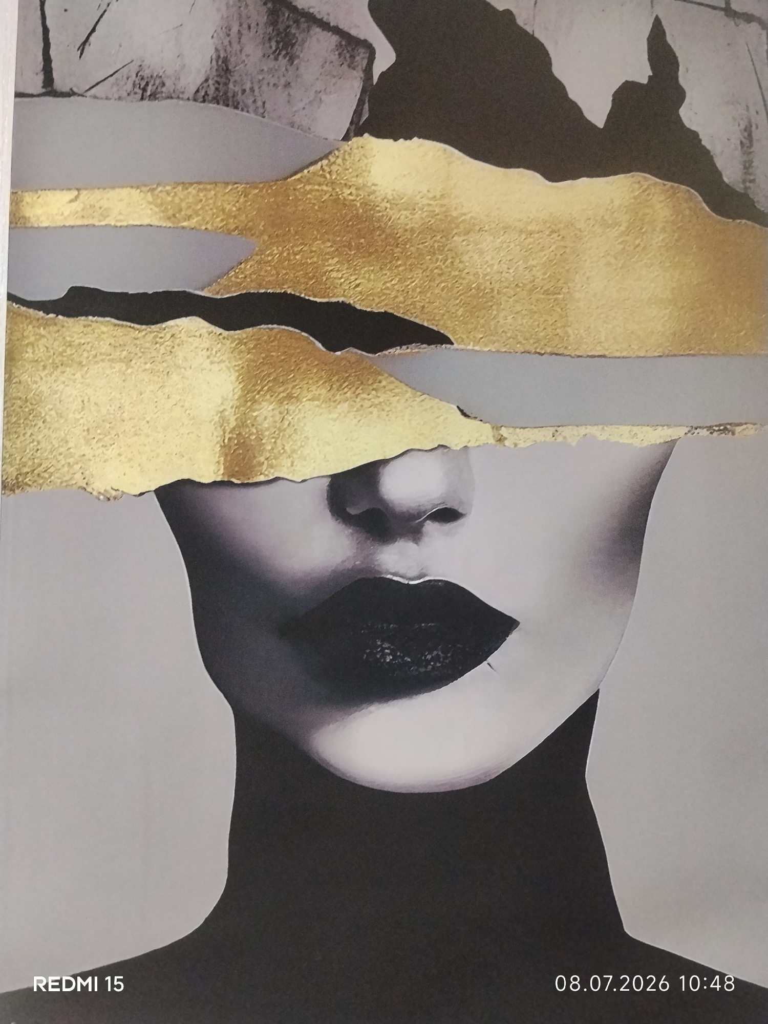 This is a close-up, vertically oriented, waist-up photographic portrait of a stylized representation of a woman's face, rendered in a collage-like abstract style. The background is a plain, light grey color. The upper portion of the image features abstract shapes in shades of grey, black, and gold. Two prominent horizontal bands of textured gold are layered over grey and black abstract forms. Below these abstract elements, the face of the woman is depicted. Her eyes are obscured by the gold and grey collage elements. She has dark, full lips with a matte finish. Her neck and shoulders are shown in shadow, with the majority of her body rendered in black. A timestamp "08.07.2026 10:48" and the text "REDMI 15" are superimposed in the lower right and lower left corners of the image, respectively. There is no discernible information about a specific location in the city of Bălți, Moldova, within the image itself.