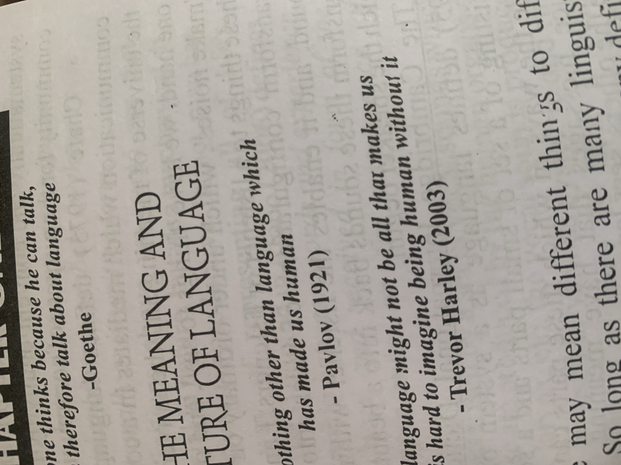 The image shows a page from a book with text printed on it. The text is in English and discusses language. There are no people, actions, or interactions visible in the image. The environment is a book's interior. There is no information within the image to suggest a location in Jauro Yinu, Nigeria.