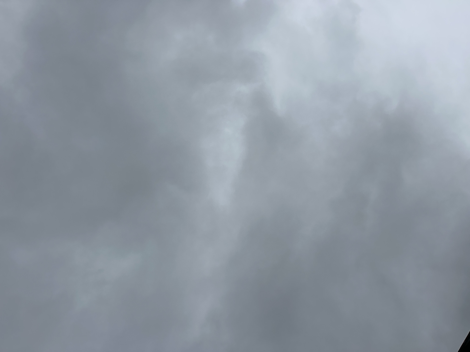 The image depicts an overcast sky with dense, grey clouds. The lighting suggests a diffused, possibly rainy, day. There are no discernable landmarks, people, or objects in the frame, making it impossible to determine a specific location within London, United Kingdom, or any other city. The scene is entirely focused on the atmospheric conditions of the sky.