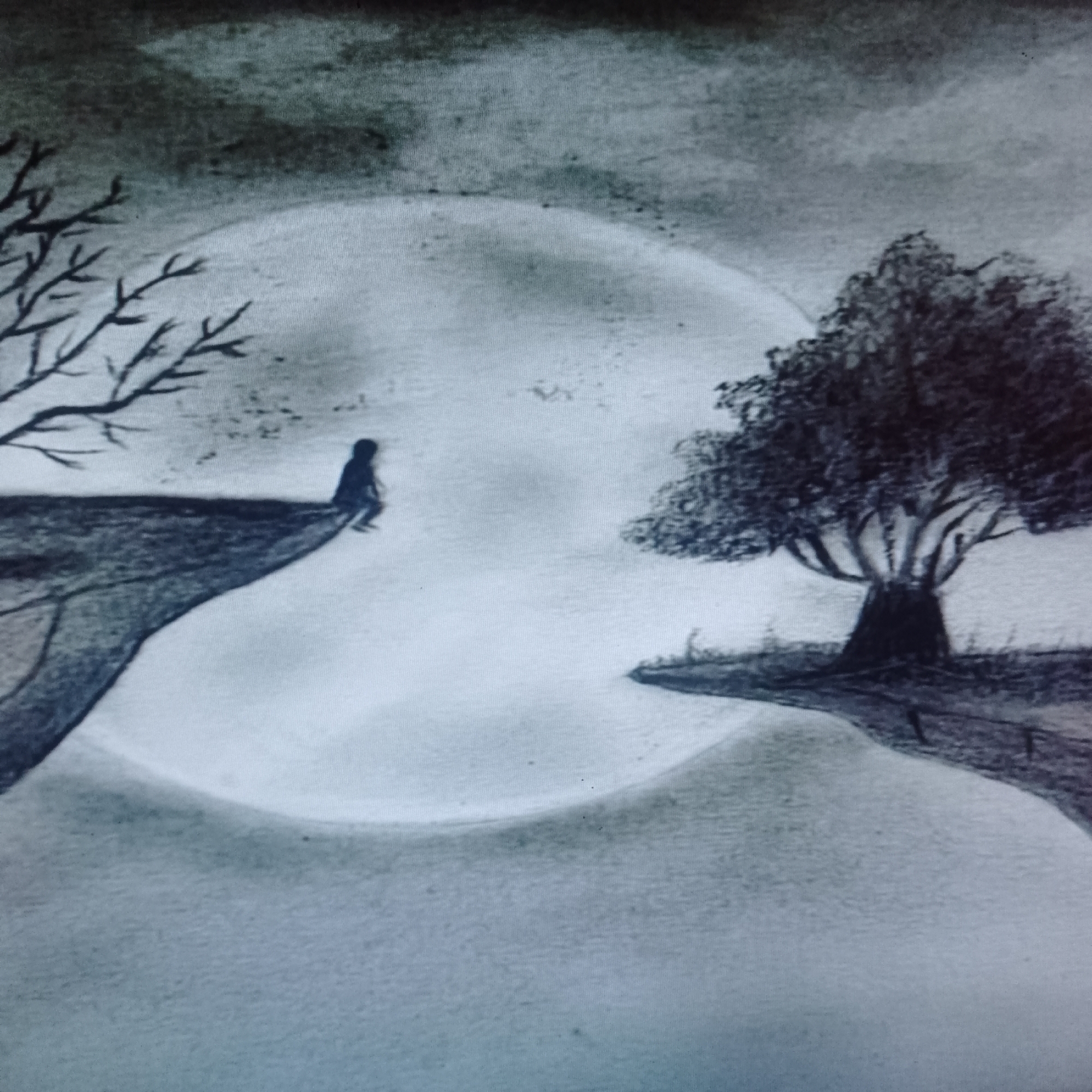 A charcoal drawing depicts a solitary figure seated on the edge of a cliff under a large, bright moon. The cliff with the figure has a bare tree extending from its edge. Across a large expanse, another cliff has a full tree with foliage. The sky is overcast. Location: Unknown, Unknown. There is no visible city in the image. The action is a person sitting.
