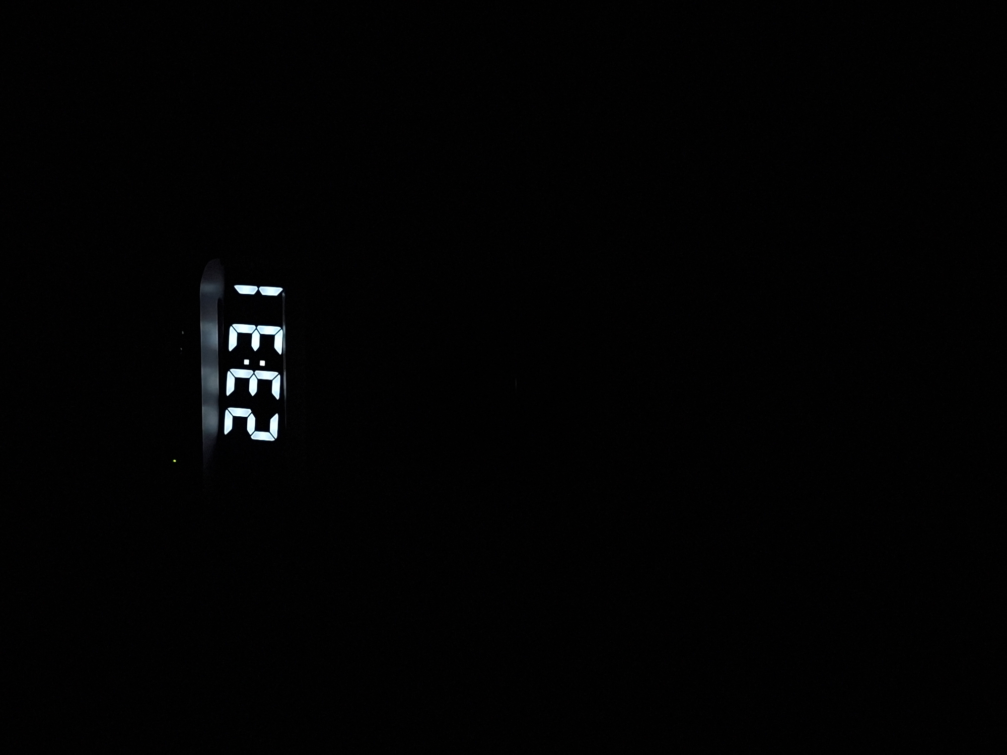 A digital clock displays the time 23:31 against a black background. A small green light is visible to the left of the clock display.