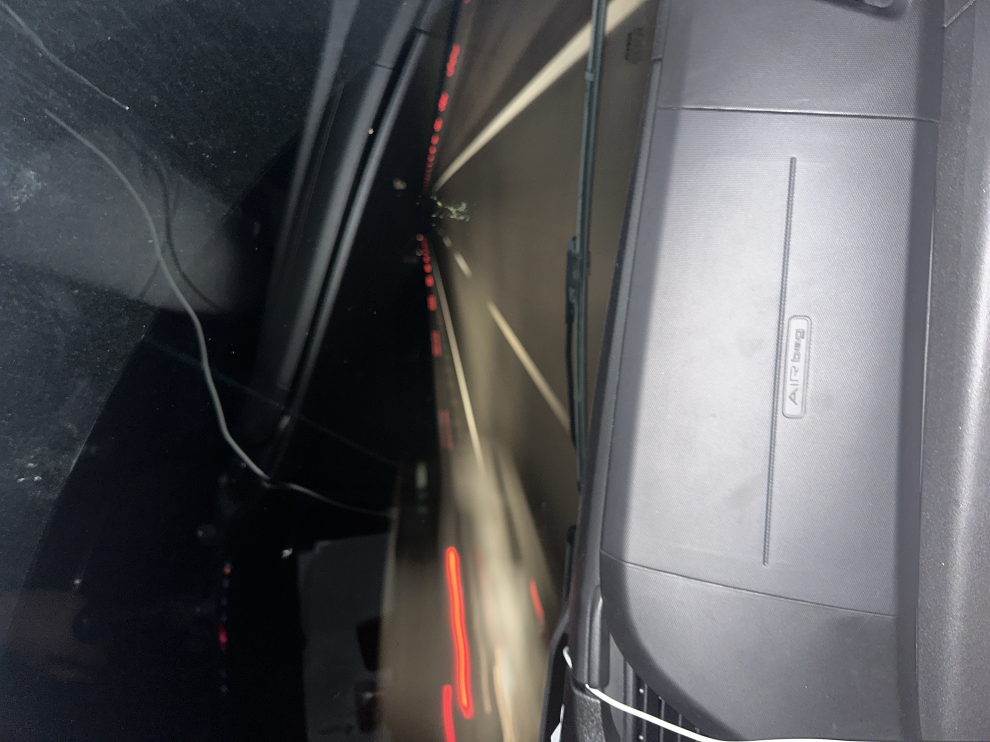 The image shows the interior of a car, specifically the dashboard and windshield, while driving through a tunnel. The "Airbag" label is visible on the dashboard. The view through the windshield shows the tunnel walls with lights, suggesting the car is in motion. The tunnel's location is purportedly in Malko Tranovo, Bulgaria.