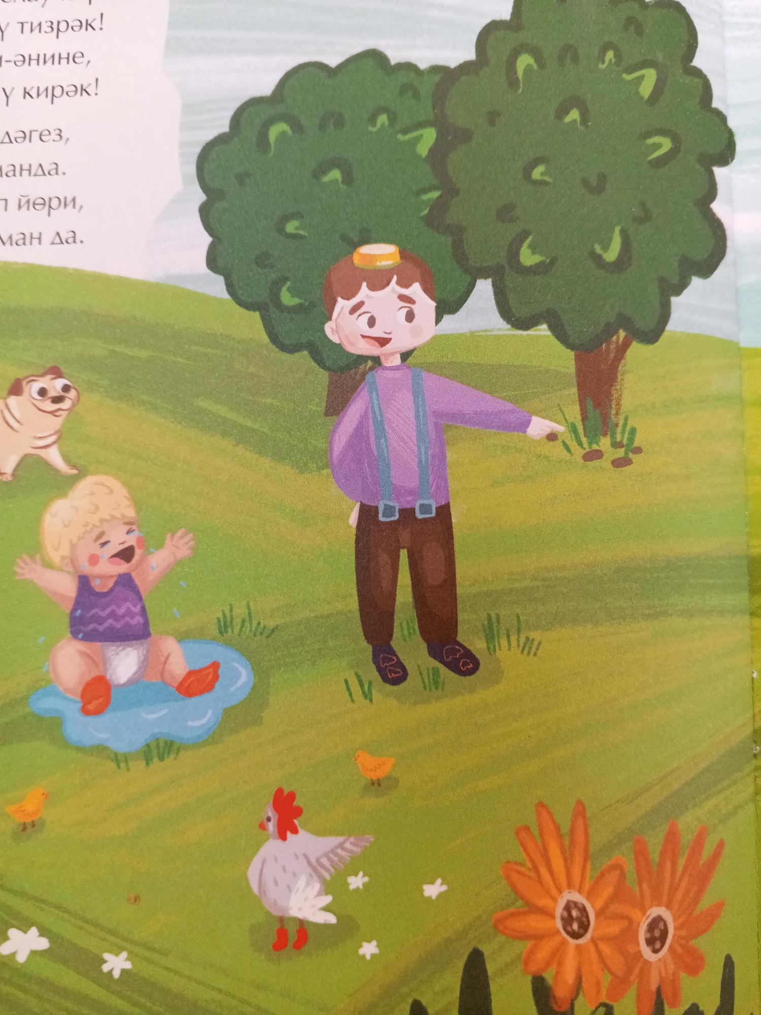 The image depicts a colorful, cartoon-style illustration of a grassy field with a few trees. In the foreground, a baby is sitting on the grass and crying, with tears shown falling from its eyes. A small, tan-colored dog with large ears is looking at the baby. To the right of the baby, a boy with brown hair and a purple shirt with suspenders is pointing. In the background, there are two large green trees. Several small yellow chicks and a white hen with red legs are scattered across the grass. Two orange flowers are also visible in the lower right corner. The text on the left side of the image appears to be in a non-Latin script, possibly Cyrillic, and its content is not described. The image does not contain any specific elements that would indicate its location within the city of Chistopol, Russia.
