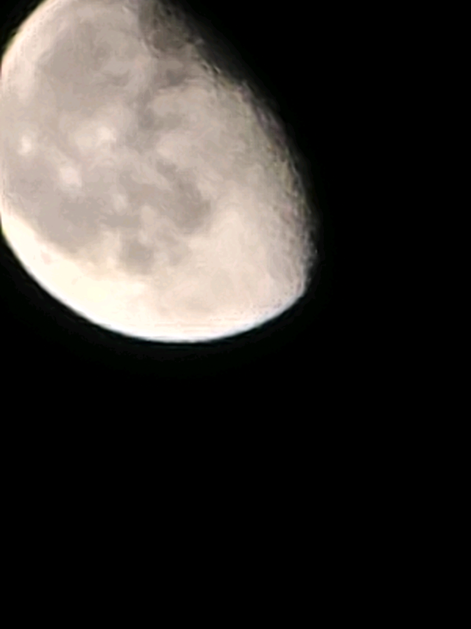 The image is a close-up of the moon against a black sky. The moon is partially illuminated, showing its craters and surface details. The bottom right of the image is entirely black, suggesting the moon is not fully visible or is near the horizon. There are no discernible elements of the city of Yambol, Bulgaria, in this image.