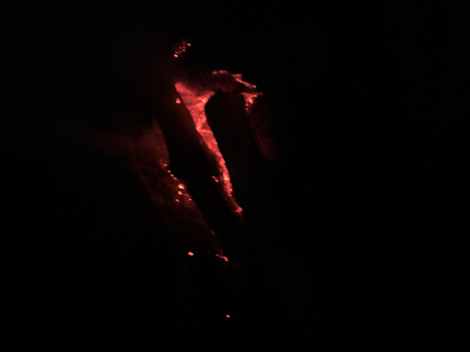 In a dark environment, a blurry, reddish-orange form resembling a hand with elongated fingers and an indistinct palm area is visible. The source of the light illuminating the form is not apparent. The location is Юзуфоўскі сельскі Савет, Belarus, but there is no additional information about the setting within that region.