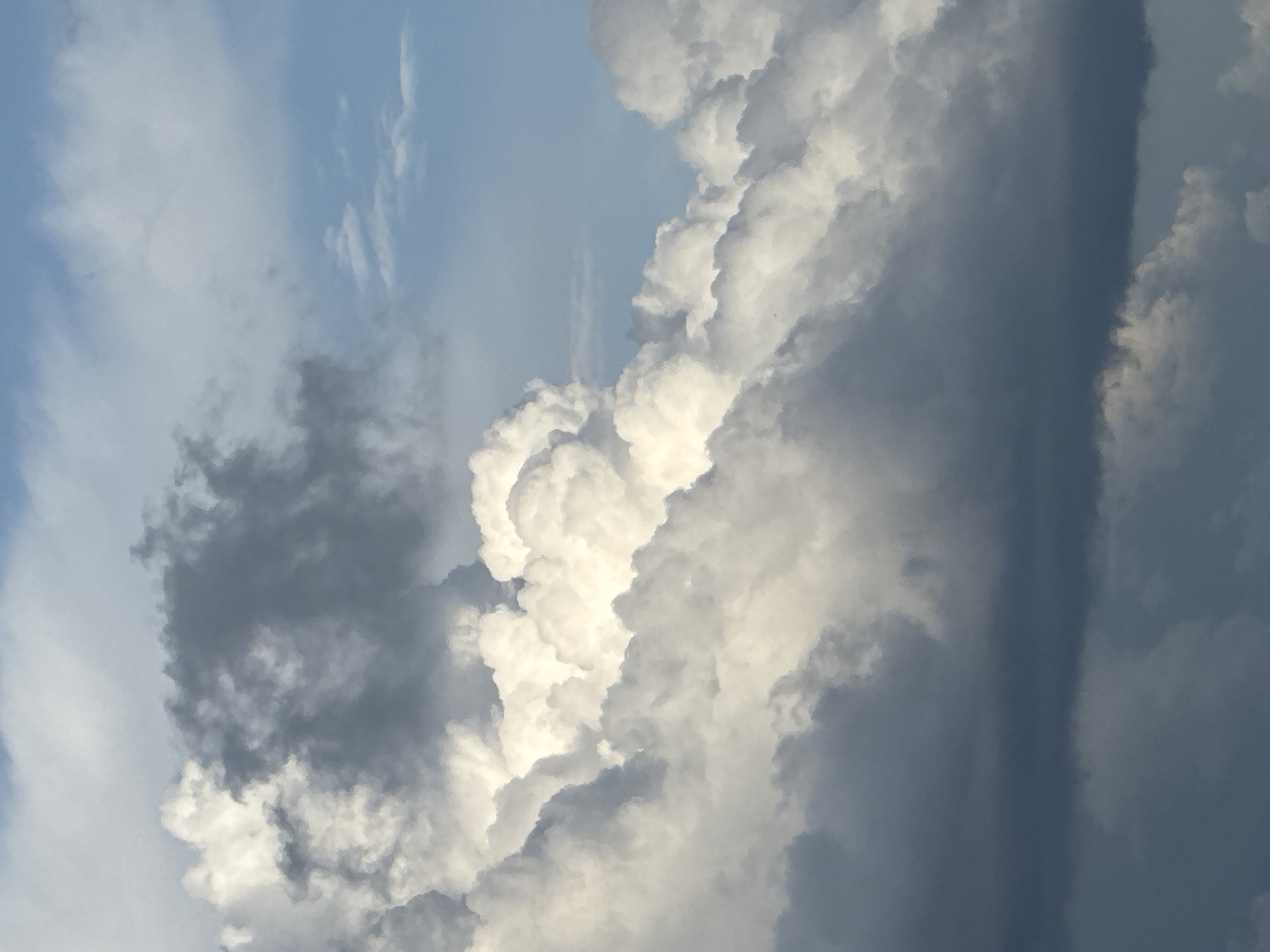 The image depicts a sky filled with cumulus clouds. The clouds range in color from bright white to dark gray, suggesting varying thicknesses and densities. Patches of blue sky are visible between the clouds. The image does not provide enough information to determine the location or the presence of people or objects on the ground. The information regarding Krasnodar, Russia cannot be confirmed from the image.