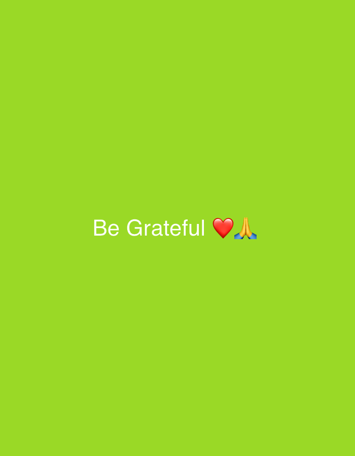 The image displays a simple graphic design with a solid, vibrant lime green background. In the center of the frame, slightly above the vertical midpoint, white text reads "Be Grateful." The font is a clear, sans-serif style. Immediately to the right of the word "Grateful," there is a red heart emoji (❤️). Following the heart emoji, also on the same horizontal line, is a praying hands emoji (🙏) depicted with a light skin tone. The overall impression is one of encouragement and positivity, focusing on the theme of gratitude. There are no other subjects, objects, or activities depicted, and no specific location or time of day is indicated.