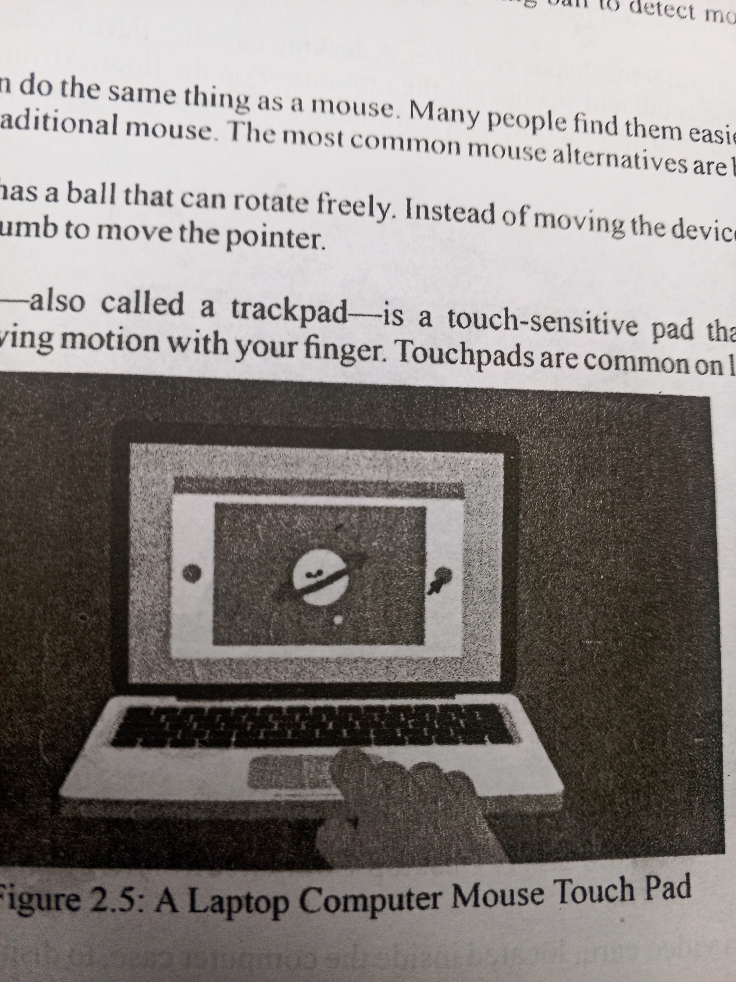 This media file shows a close-up of a page from a book, featuring text and an illustration. The text discusses computer mice and trackpads, with a particular focus on how they function. The illustration is a black and white drawing of a laptop computer with a hand touching its trackpad. The laptop screen displays a stylized cursor or icon. The overall setting appears to be educational, likely a textbook or reference material. The visible text includes phrases like "detect mo", "same thing as a mouse", "touch-sensitive pad", and "Figure 2.5: A Laptop Computer Mouse Touch Pad". There are no clear indicators of time of day, weather, or specific emotions. The location context provided is Jalingo, Nigeria, which is not directly discernible from the image itself but is given as contextual information.