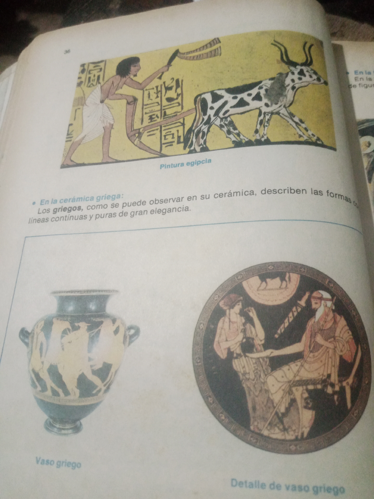 The image displays a page from a book featuring historical art. At the top, a depiction of ancient Egyptian art shows a man plowing with a spotted bull, accompanied by hieroglyphics and the caption "Pintura egipcia." Below this, a bullet point reads, "En la cerámica griega: Los griegos, como se puede observar en su cerámica, describen las formas continuas y puras de gran elegancia." Further down, a Greek vase with black-figure pottery depicting figures in motion is shown, labeled "Vaso griego." To its right, a close-up of a detail from a Greek vase illustrates two figures, one standing and one seated, also labeled "Detalle de vaso griego." The environment appears to be an indoor setting, likely a study or library, with natural light illuminating the page. The specific location in Santa Ana, Venezuela, is not discernible from the provided image.