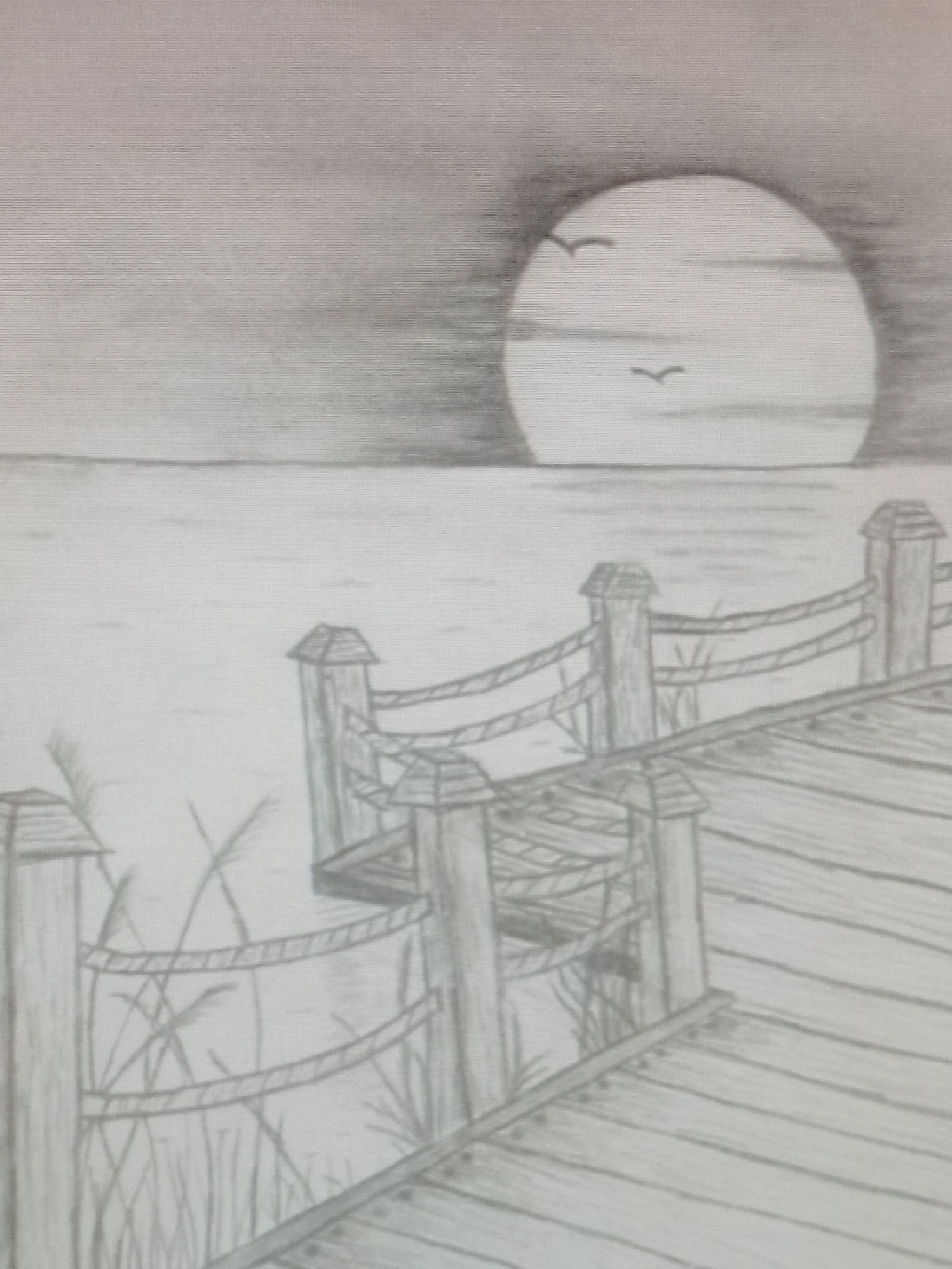 The image is a pencil drawing depicting a pier extending into a body of water. The pier is constructed of wooden planks and posts, connected by rope railings. Vegetation grows near the pier's edge. A large, circular shape, possibly the sun or moon, dominates the background, partially obscured by a horizontal band, likely clouds. Two birds are silhouetted against the light. The sky and water have been shaded to create depth and perspective. Location: Unknown, Unknown.