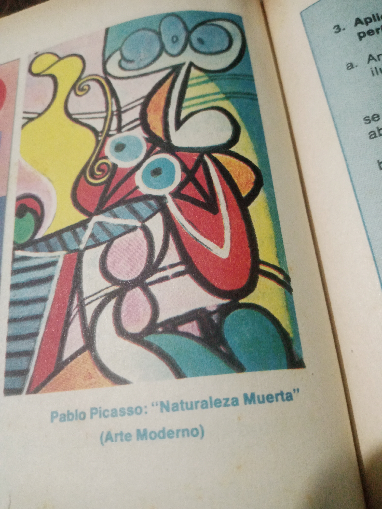 The image displays a colorful abstract painting with a yellow vase, blue eyes, and red and orange shapes. Below the painting, text reads "Pablo Picasso: 'Naturaleza Muerta'" and "(Arte Moderno)". To the right of the painting, a light blue section of a page shows text with a numbered list. The image appears to be a photograph of a page from a book or magazine, showing the painting and accompanying text. There is no information about the city of Santa Ana, Venezuela, present in the image.