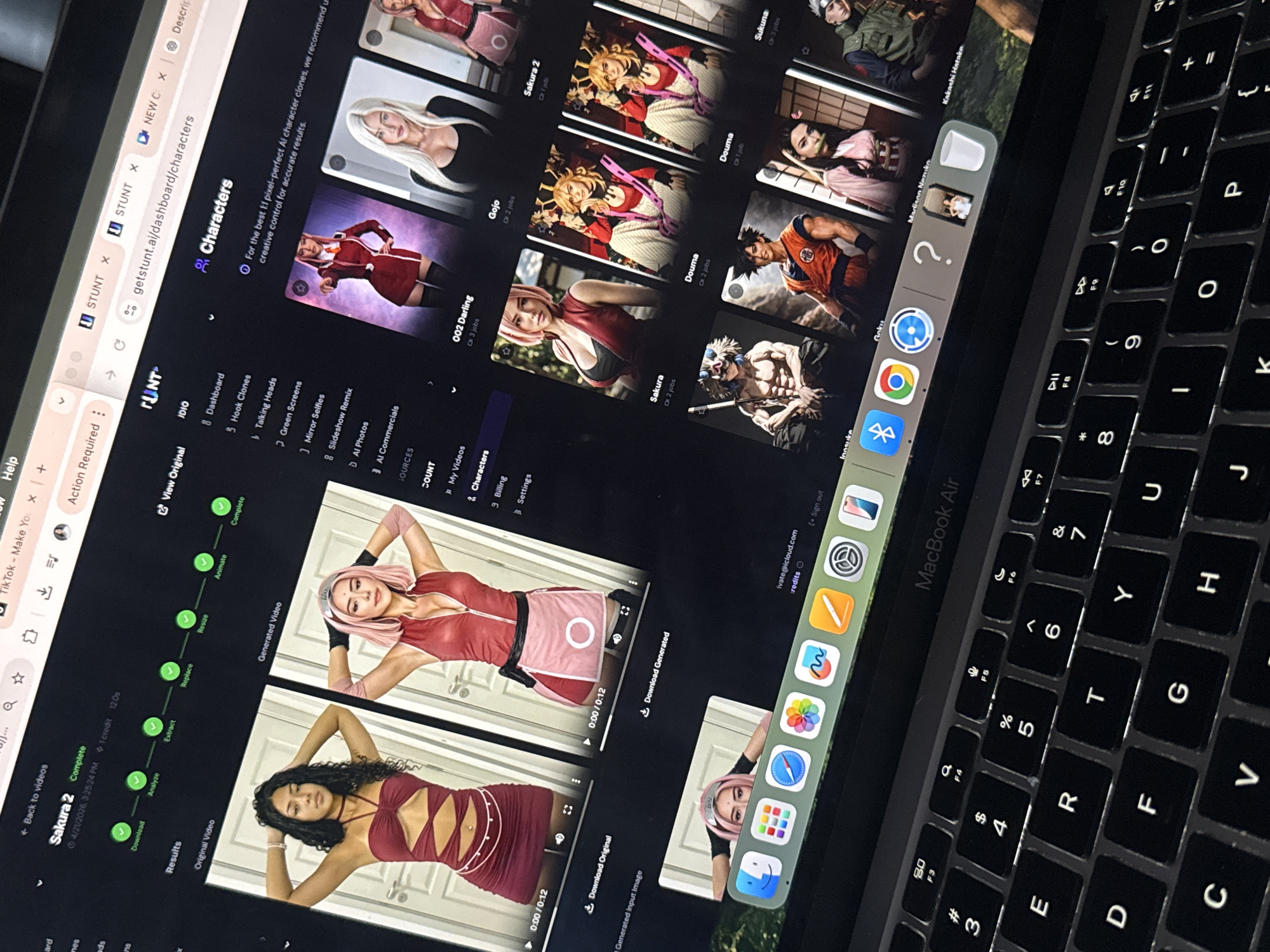 The image captures a close-up, angled view of a MacBook Air laptop, likely in low-light conditions given the illuminated keyboard. The black keyboard with white backlighting is visible on the right side of the frame.
The laptop screen displays a web application with the URL `getstunt.ai/dashboard/characters`, identified as "STUNT" in the browser tab. The left sidebar of the website lists navigation options such as "Dashboard," "Hook Clones," "Talking Heads," "Green Screens," "Mirror Selfies," "Slideshow Remix," "AI Photos," "AI Commercials," "My Videos," "Characters," "Billing," and "Settings."
The main content area shows a "Characters" section, presenting several AI-generated character images. Visible character names include "Gojo," "Sakura," "Douma," "Sukuna," "Inosuke," "Goku," "Madison Nezuko," "Kakashi Hatake," and "002 Darling." Below this, a specific video processing sequence for "Sakura 2" is detailed, showing stages like "Analyze," "Extract," "Replace," "Resize," "Animate," and "Complete." An "Original Video" of a woman in a red outfit is shown alongside a "Generated Video" of a woman cosplaying as Sakura from Naruto, each with a 0:00/0:12 timestamp and download options.
Other visible elements include open browser tabs such as "TikTok - Make Yo," "NEW C," and "Descrip." A partial view of the macOS Dock shows icons for various applications, including Safari, App Store, Photos, Maps, Messages, FaceTime, Mail, Calendar, Google Chrome, and Bluetooth, along with a recycle bin. An "Action Required" notification is also present. User account information (`1vars@icloud.com`) and "credits" are visible near the top right of the screen.
The scene depicts an individual interacting with an AI-powered platform for character generation or video content creation, potentially for social media engagement, as suggested by the TikTok tab. The context for this activity is Davao City, Philippines.