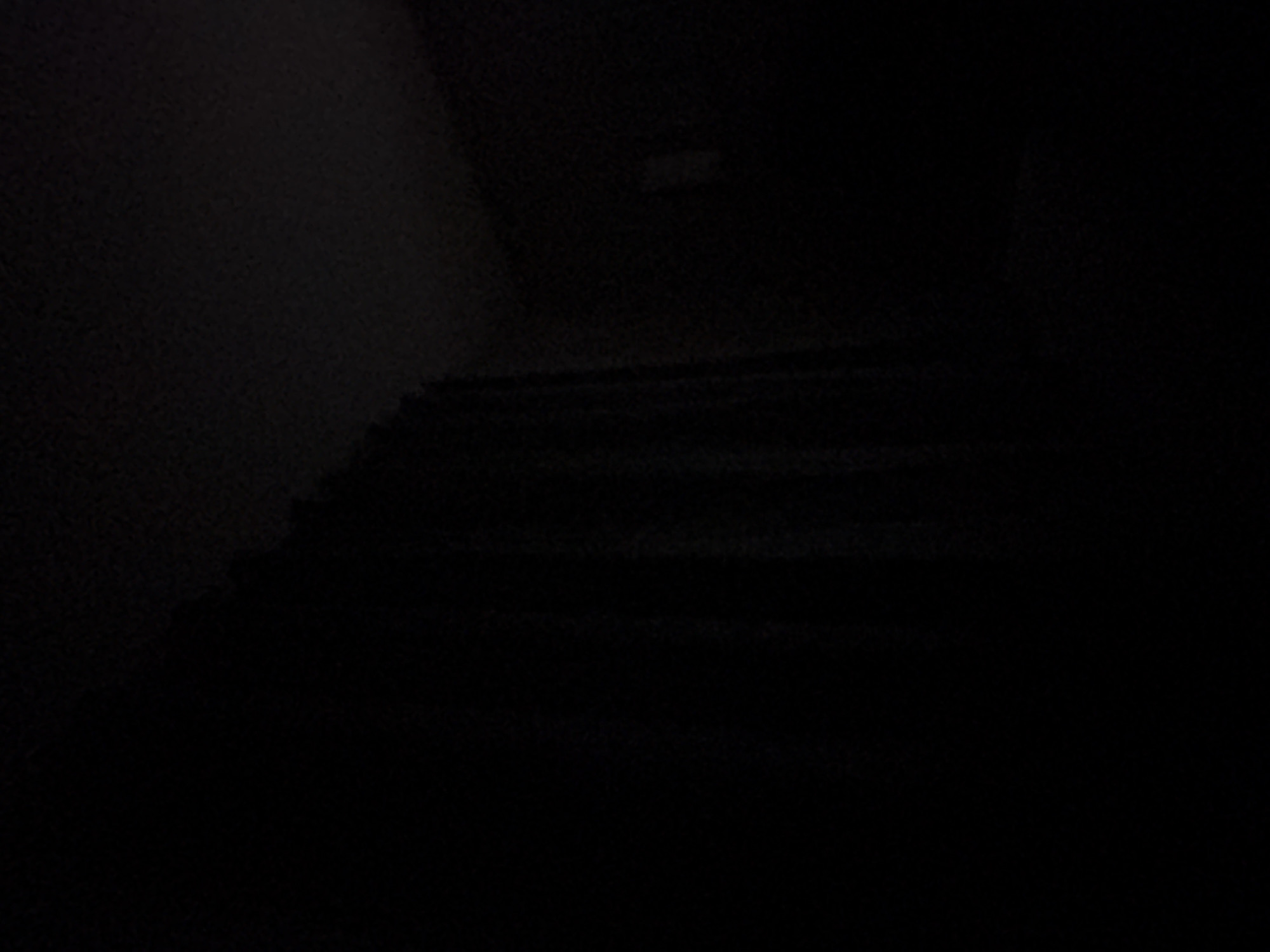 The image shows a dark staircase. Due to the darkness and lack of detail, it's not possible to determine the exact location in Burgas, Bulgaria, or provide further details about the scene.