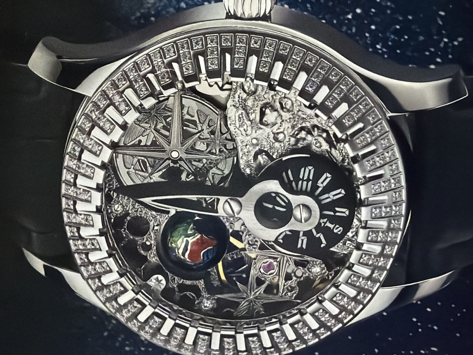The image shows a close-up of an ornate wristwatch. The watch has a silver-colored case and a black strap. The watch face is intricate, featuring diamond-studded hour markers around the outer edge. Inside, there are several smaller dials, including one displaying the date and another possibly indicating the time. A prominent feature is a globe representation with colored landmasses. There is also a compass-like design. The watch appears to be a high-end, luxury item, with detailed mechanical components visible. No information about location is available.
