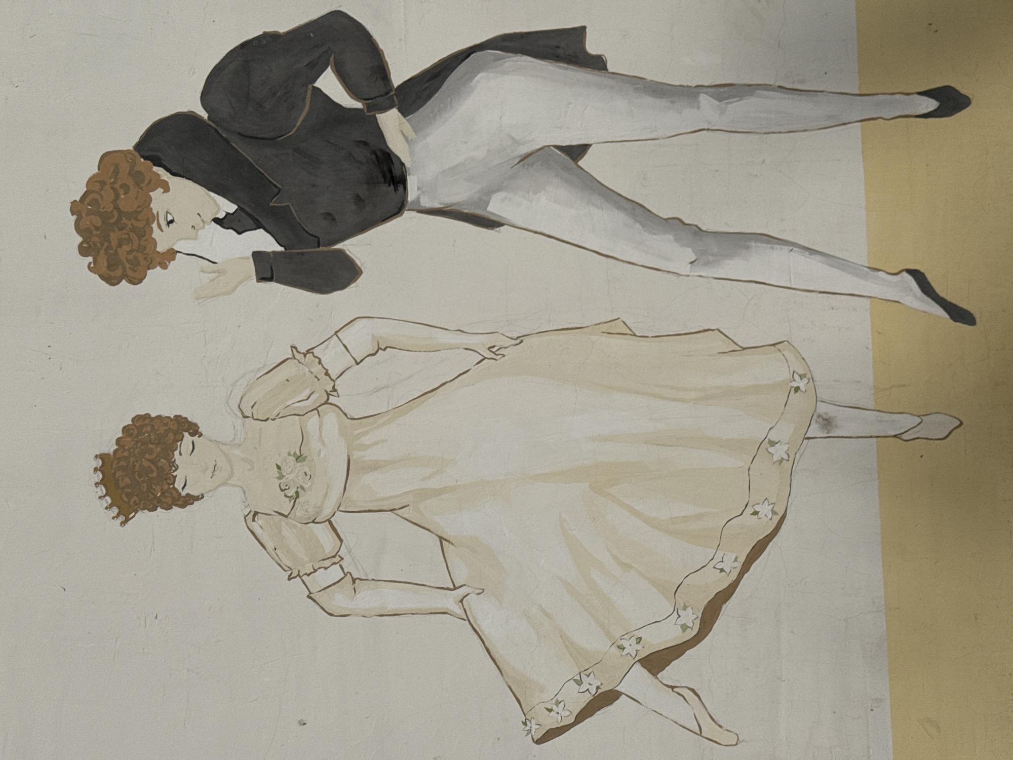 A mural depicts a man and a woman in a stylized manner. The man, located in the upper portion of the image, is wearing a dark suit jacket with light-colored trousers and black shoes. He appears to be holding a small object near his face. The woman is in the lower portion of the image, wearing a light-colored dress adorned with flower detailing. The background is a neutral tone, partially divided by a vertical yellow band. This mural can be found in the city of Cherepovets, Russia.